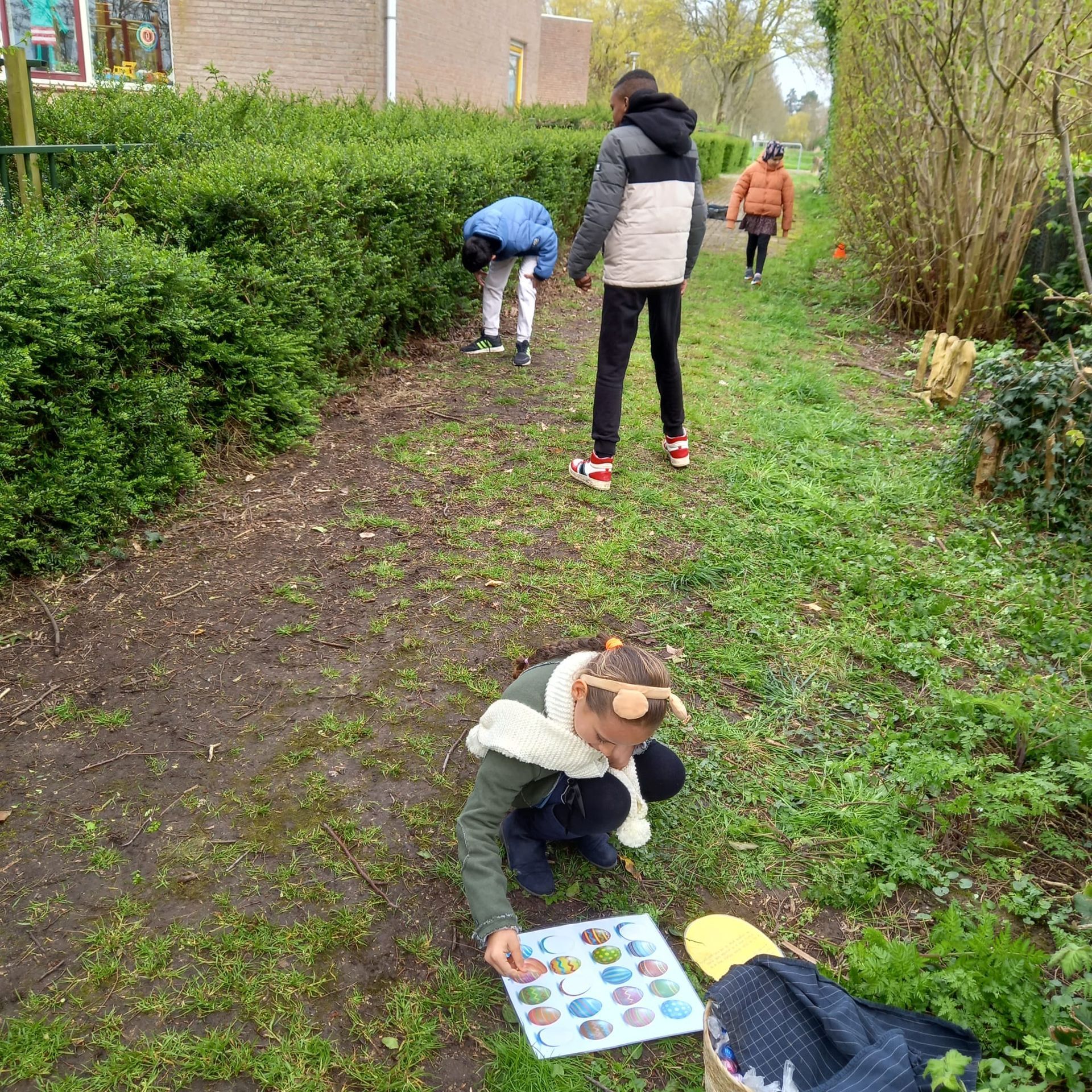 A group of children are playing a game in the grass.