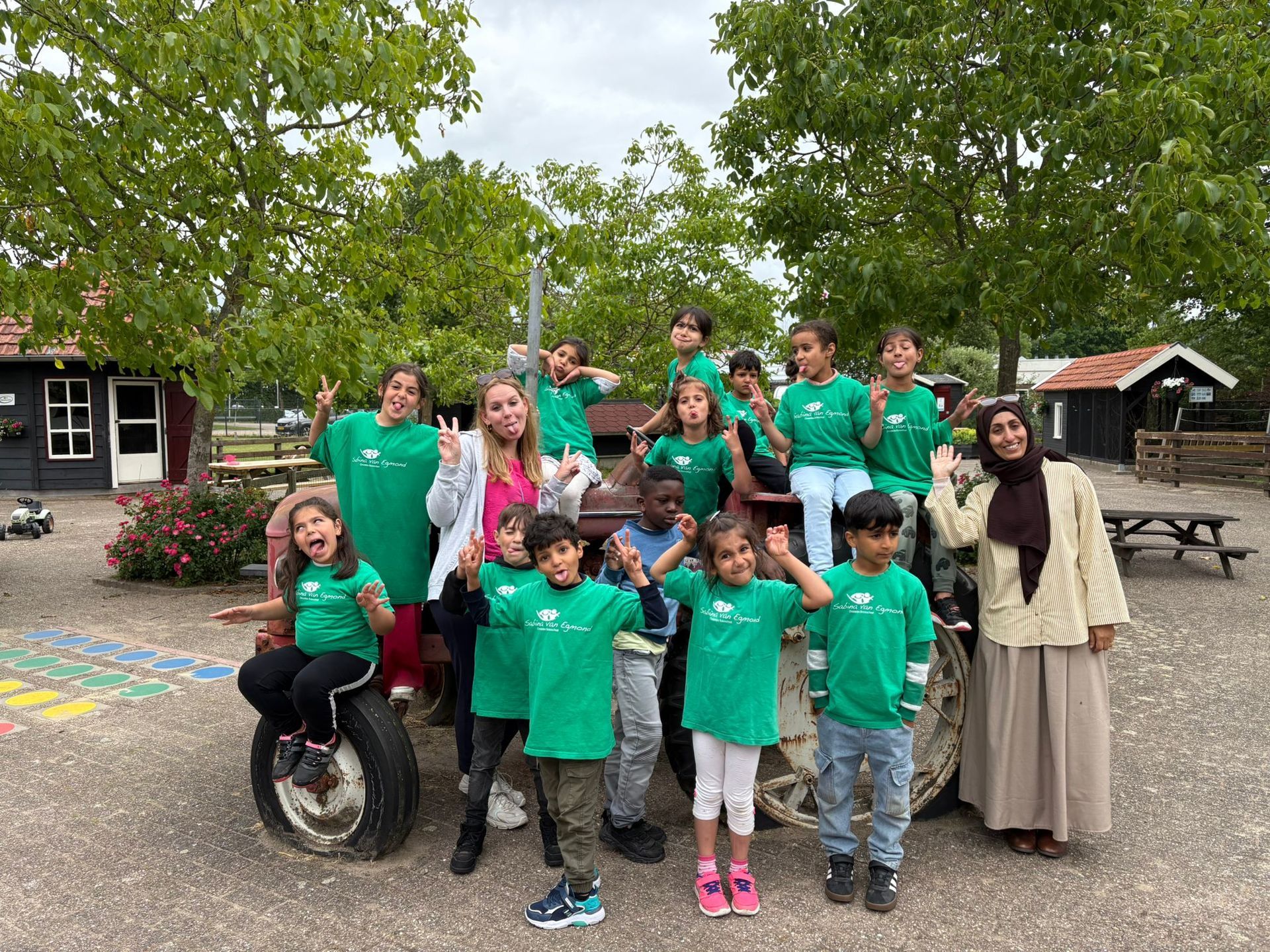 A group of children are playing on a wooden bridge in a park.