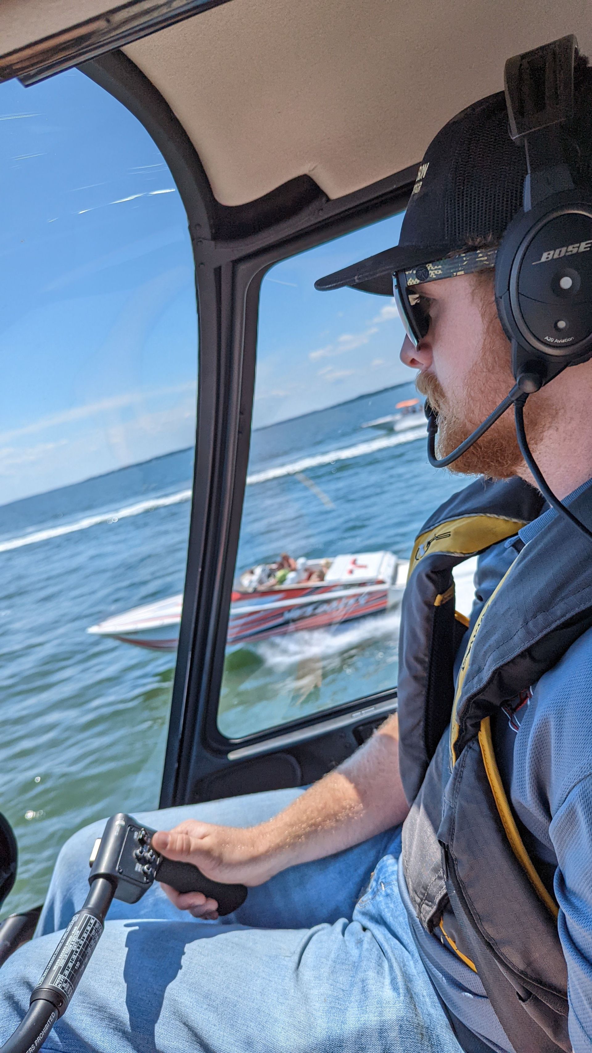 A speedboat running just out the window of an R-44