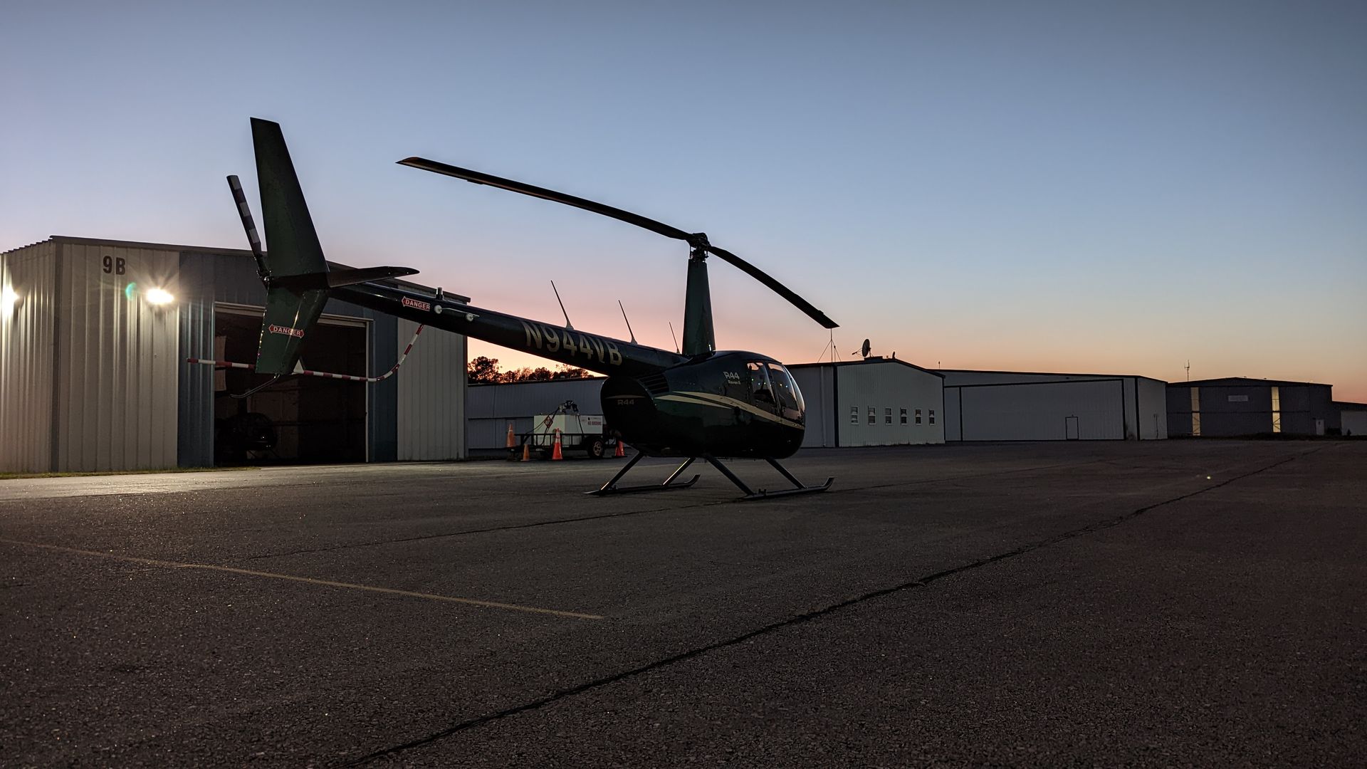 An R-44 parked at PVG at sunset