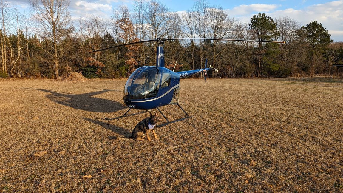 An R-22 with a German Shepard in front of it. 