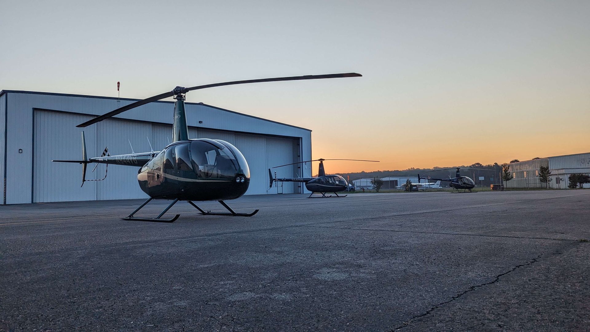 3 Robinson Helicopters on a ramp