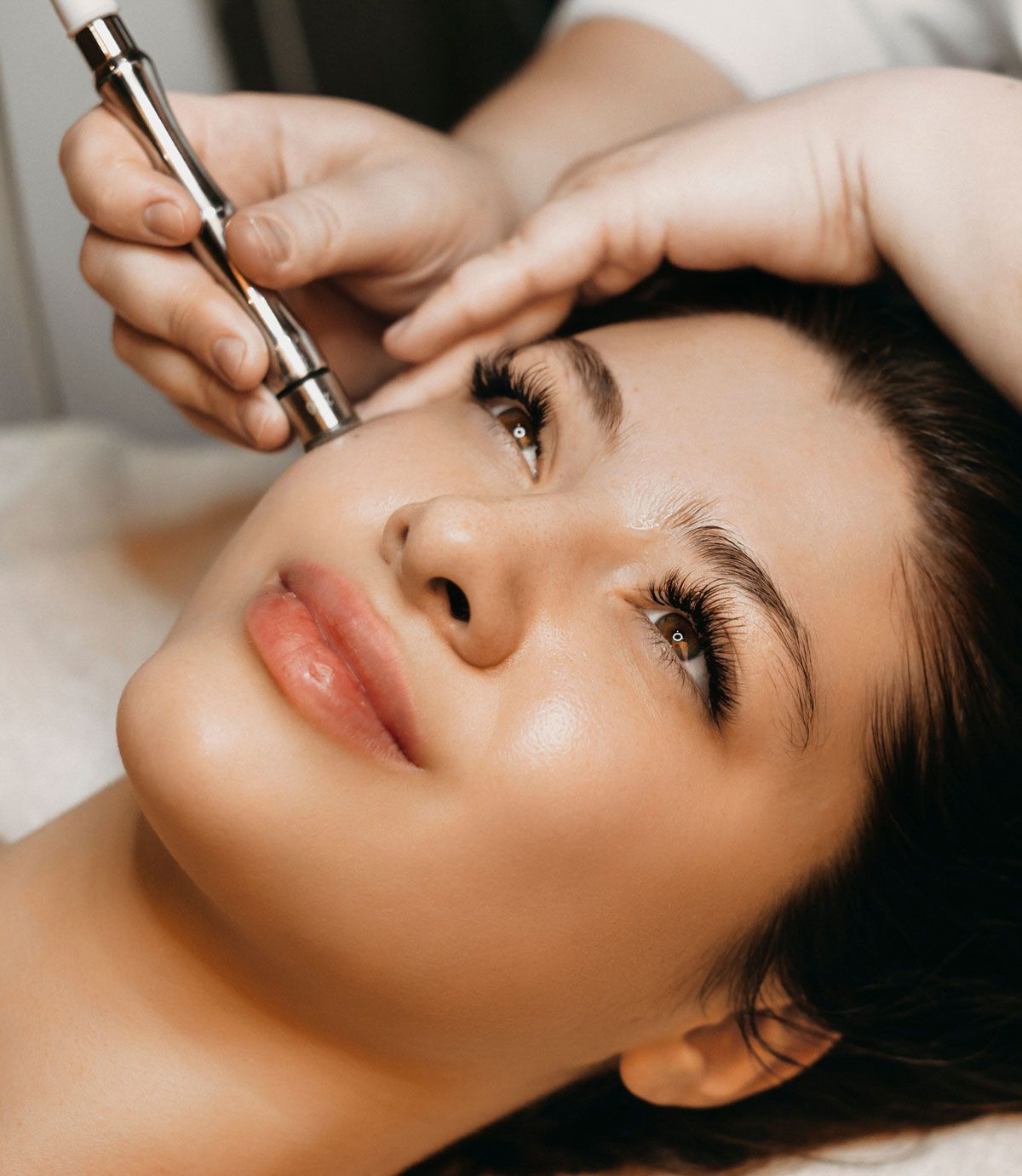 closeup of a woman's face as she undergoes microdermabrasion treatment
