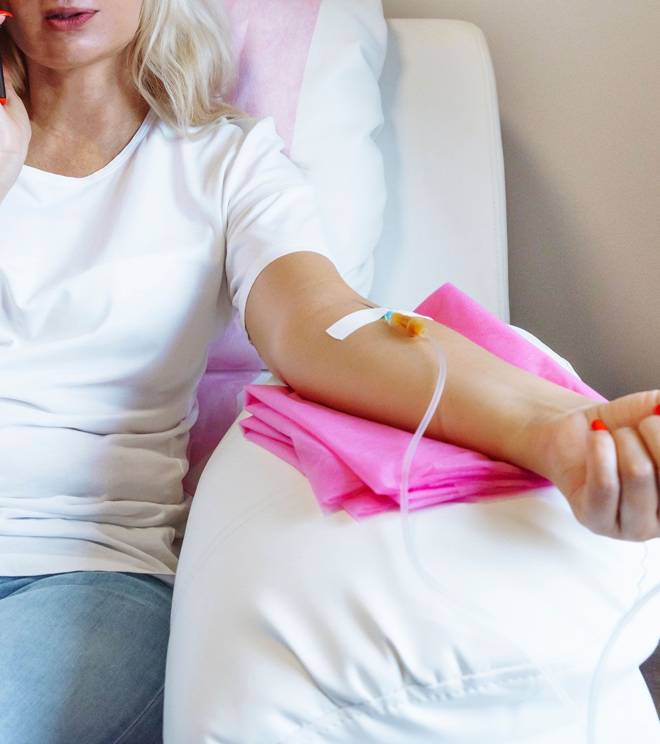 A woman in a hospital bed with an iv in her arm