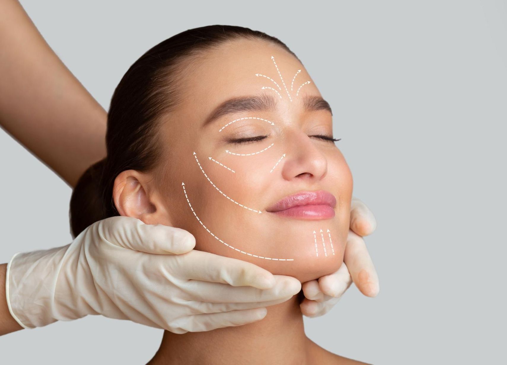 A woman is getting a facial treatment from a doctor.