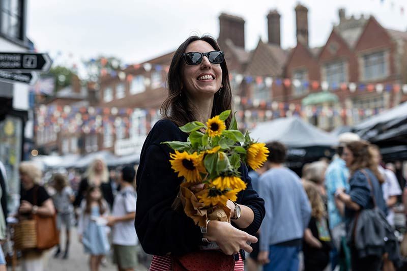 A downhill view of Arundel High Street, including shops and historic buildings