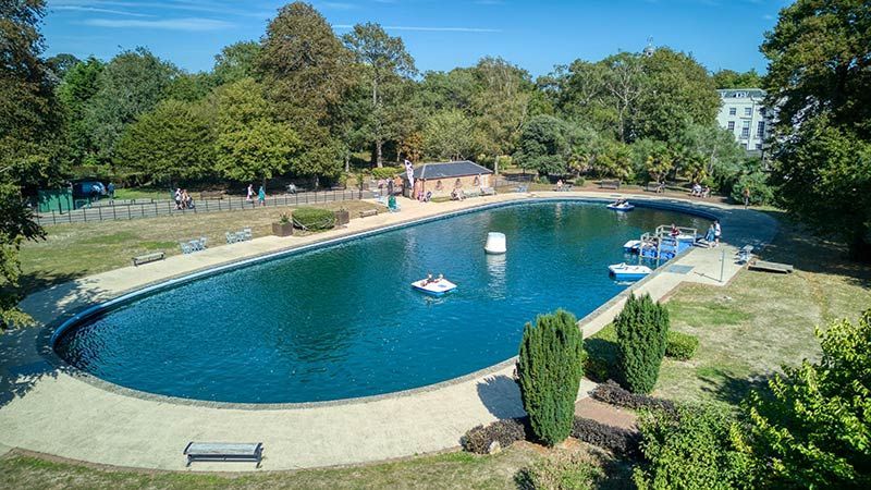 A twilight view of Hotham Park Cafe, in Bognor Regis , with surrounding trees and parkland.