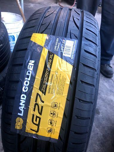 A close up of a tire with a yellow label on it.