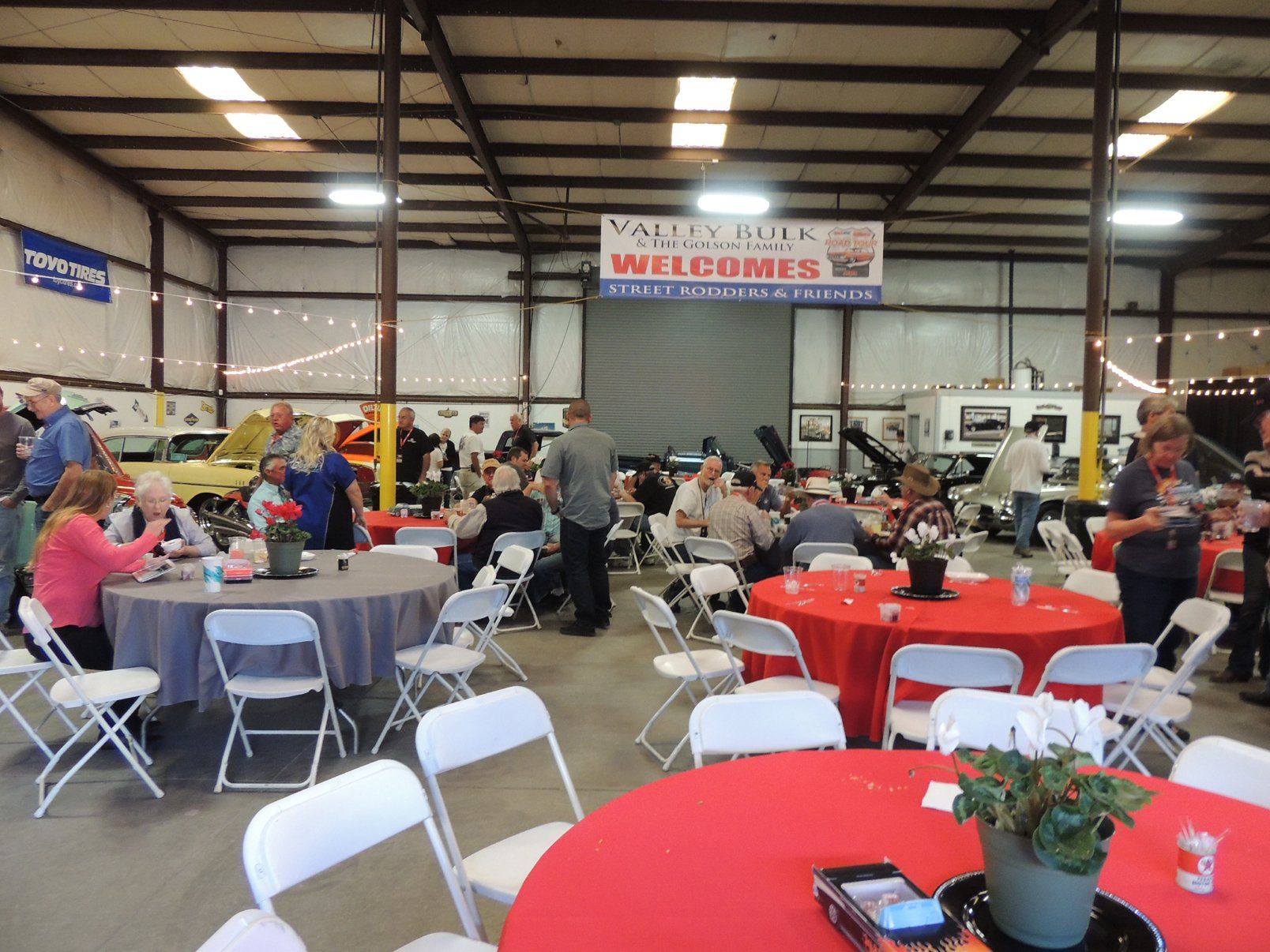A large room with tables and chairs and a sign that says welcomes