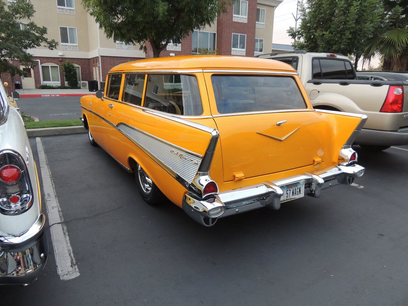 A yellow station wagon is parked in a parking lot