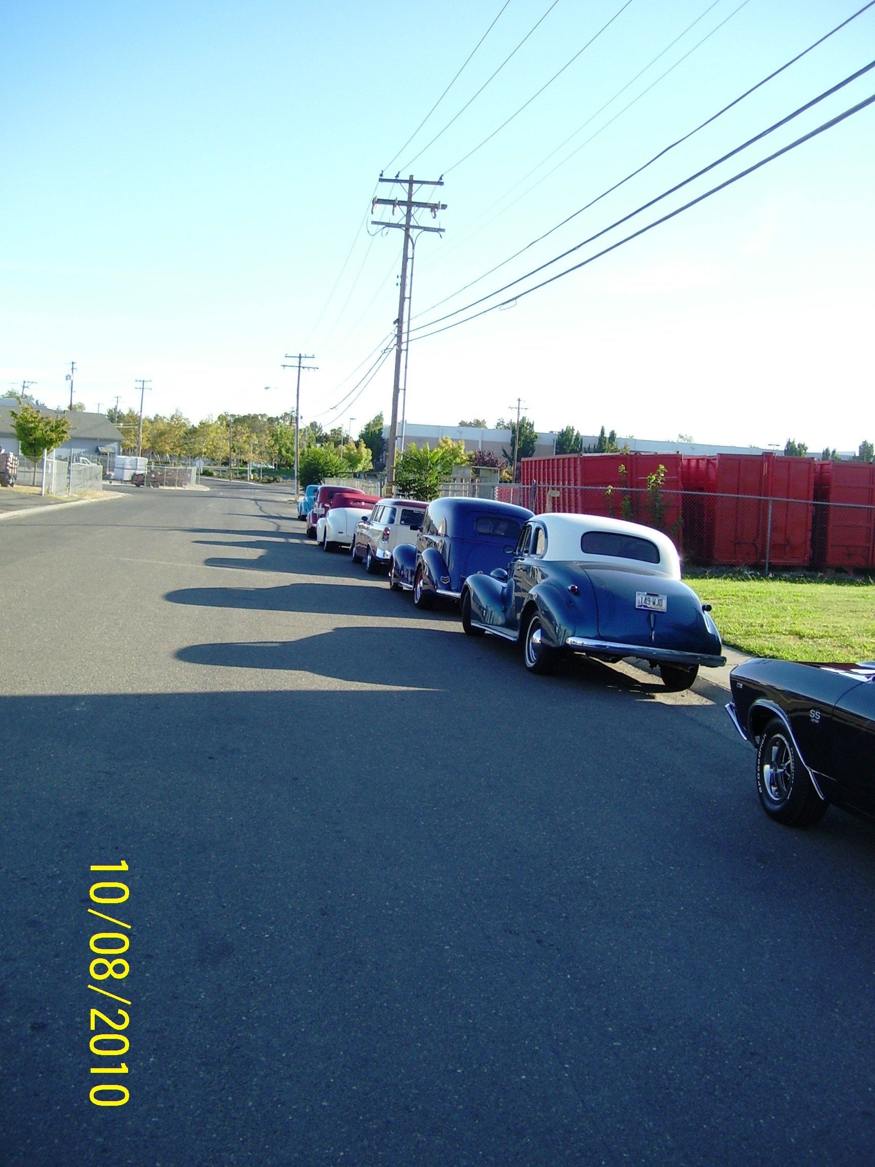 A row of cars are parked on the side of the road on 10/08/2010