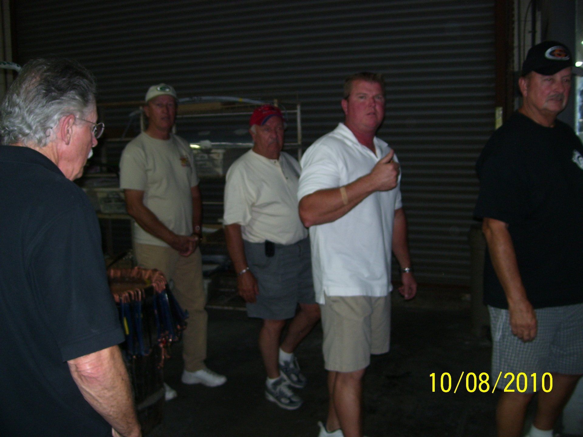 A group of men standing next to each other on 10/08/2010