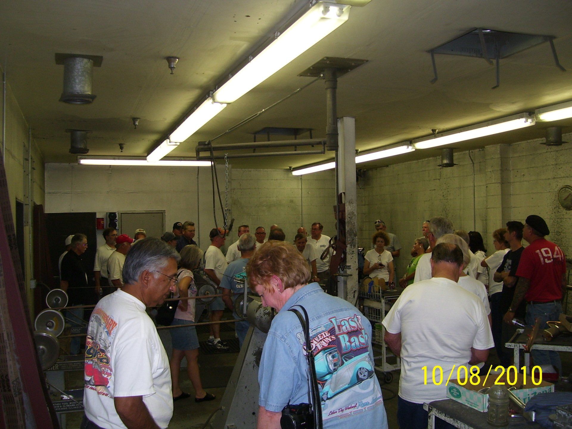 A group of people are gathered in a room on 10/08/2010