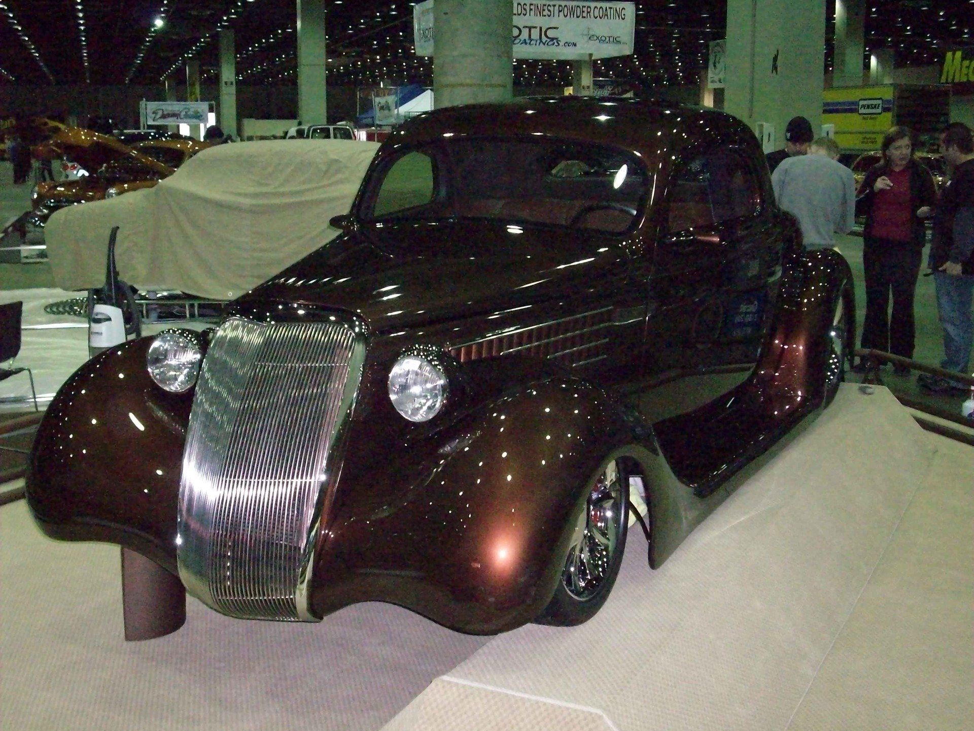 A brown car is parked in front of a sign that says u.s.