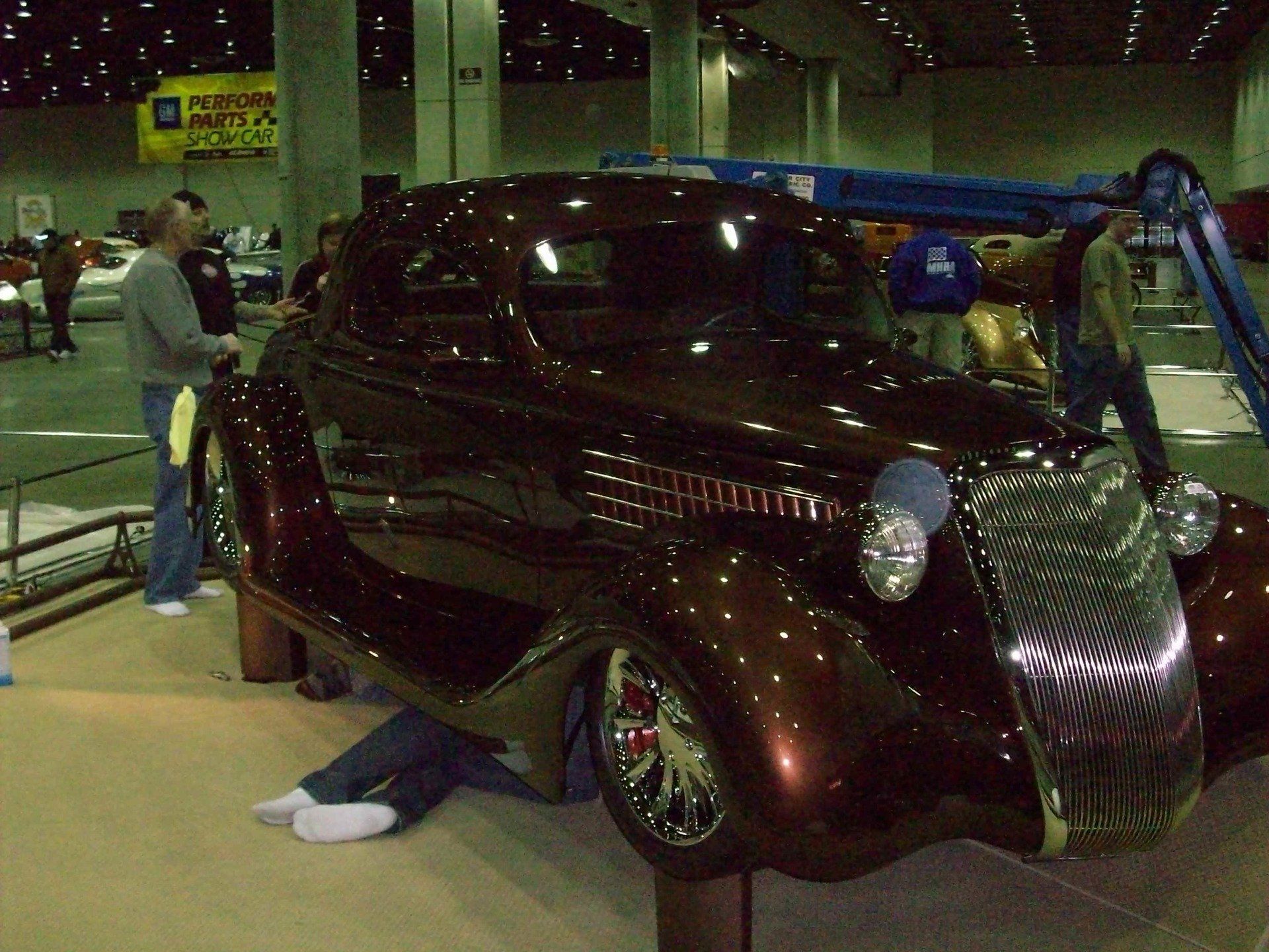 A brown car is on display at a car show