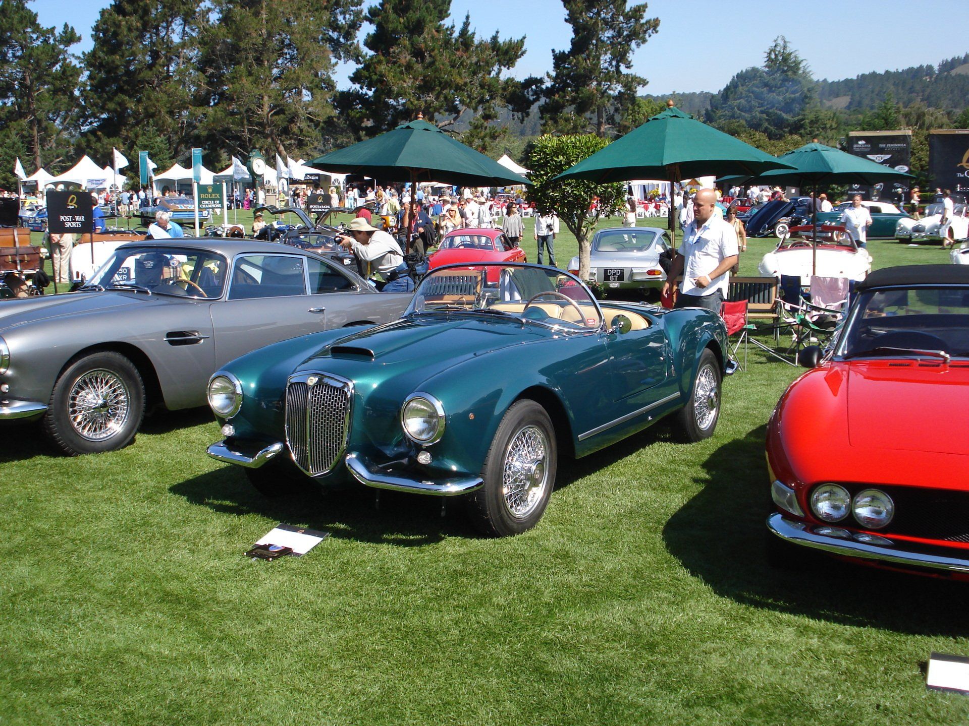 A red car is parked next to a green car