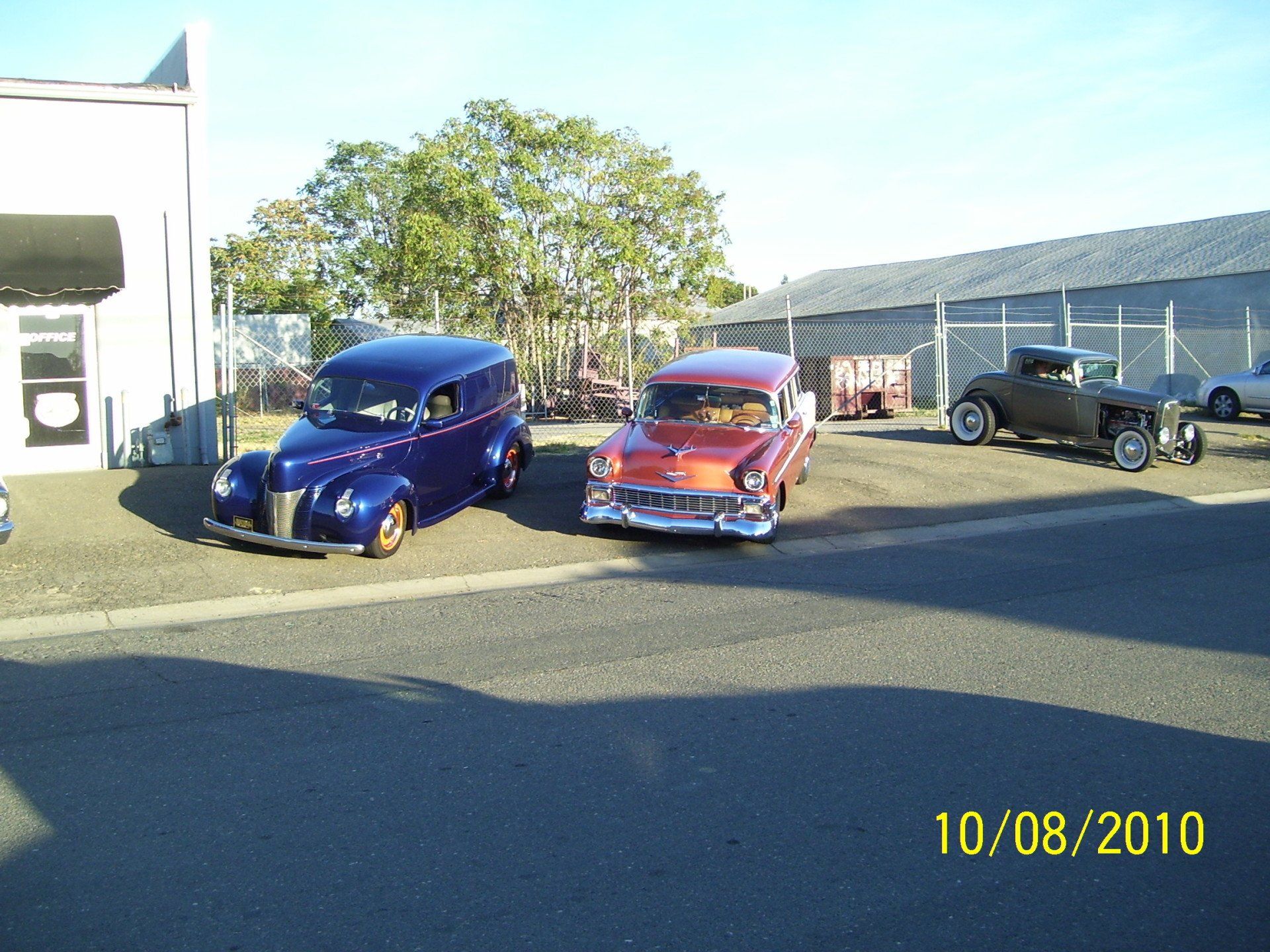 Three old cars are parked in a parking lot on 10/08/2010