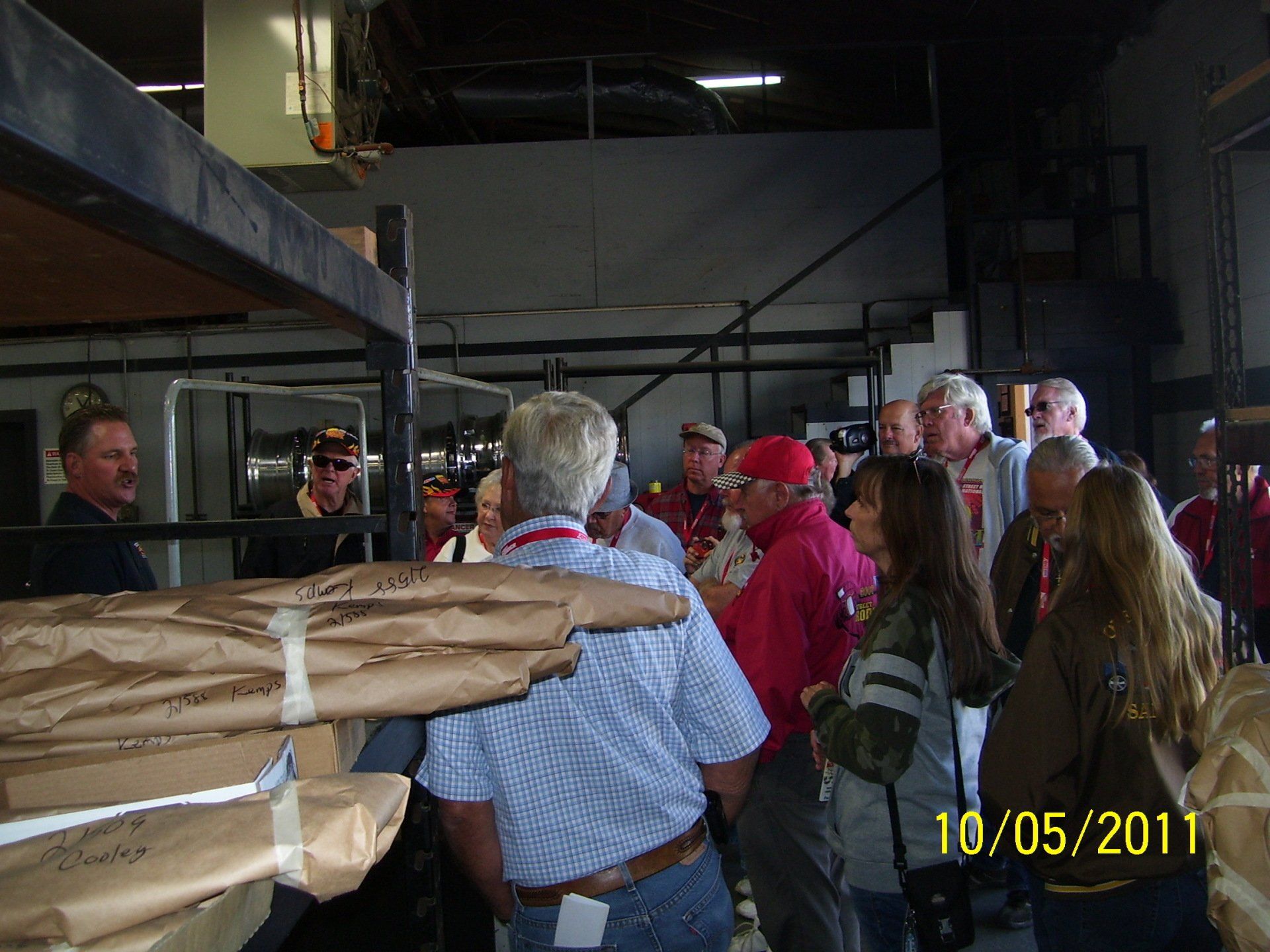 A group of people standing in a room with a date of 10/05/11