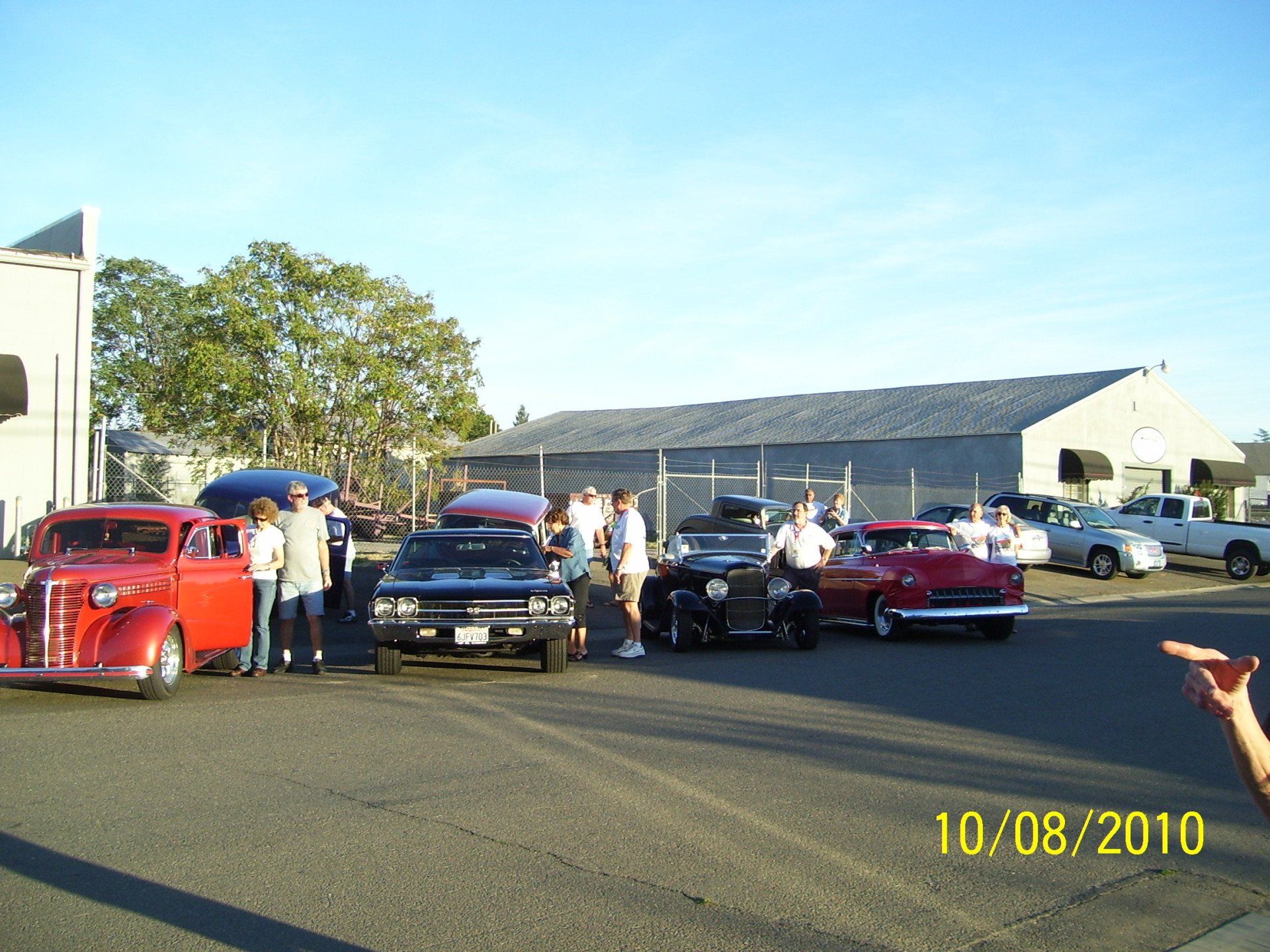 A group of cars are parked in a parking lot on 10/08/2010