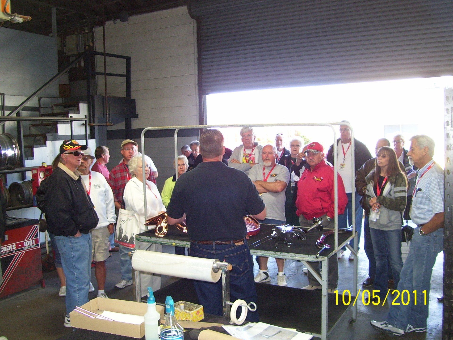A group of people standing around a table with a date of 10/05/11