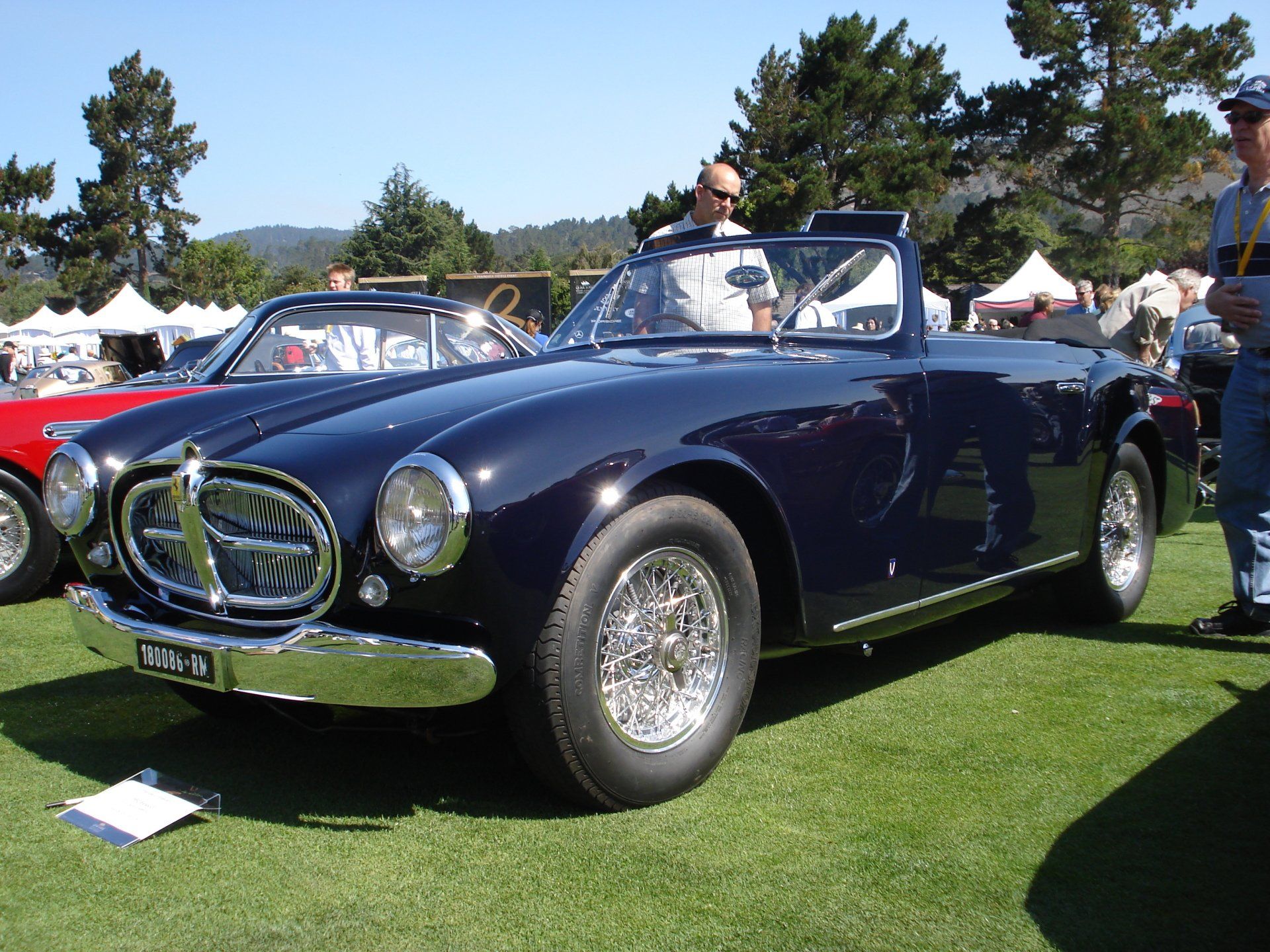 A black car with a license plate that says 10ra