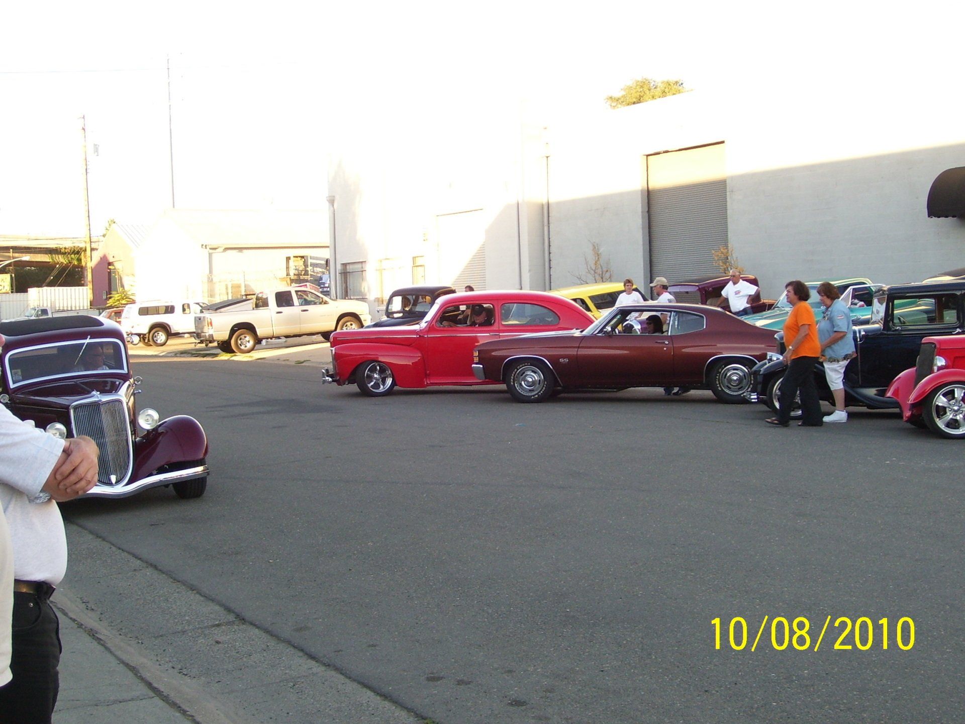 A group of cars are parked in a parking lot on 10/08/2010