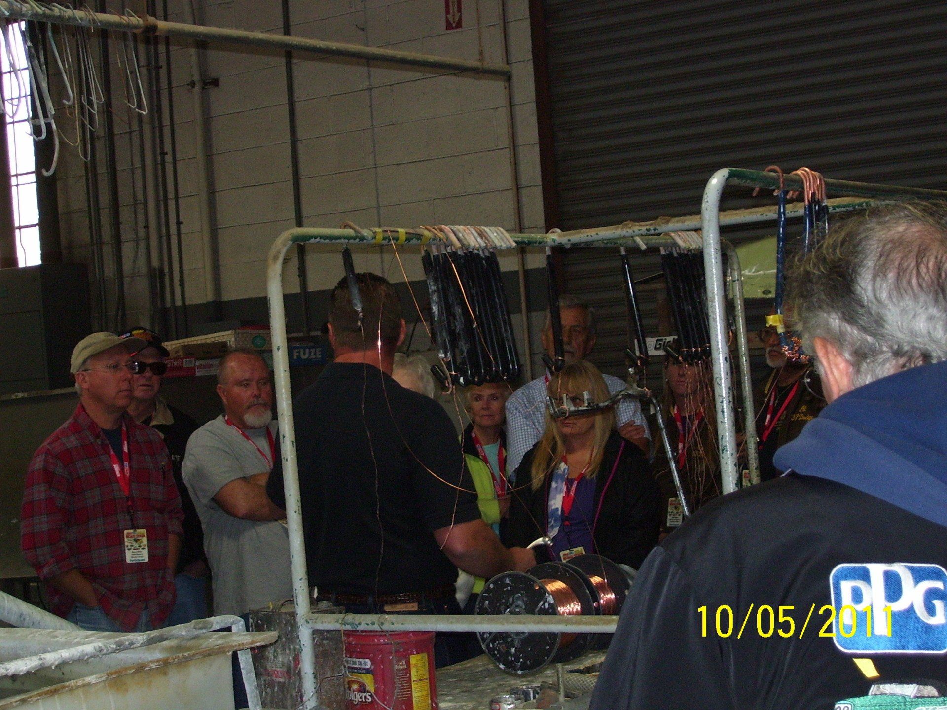 A group of people in a room with a ppg logo on their jacket