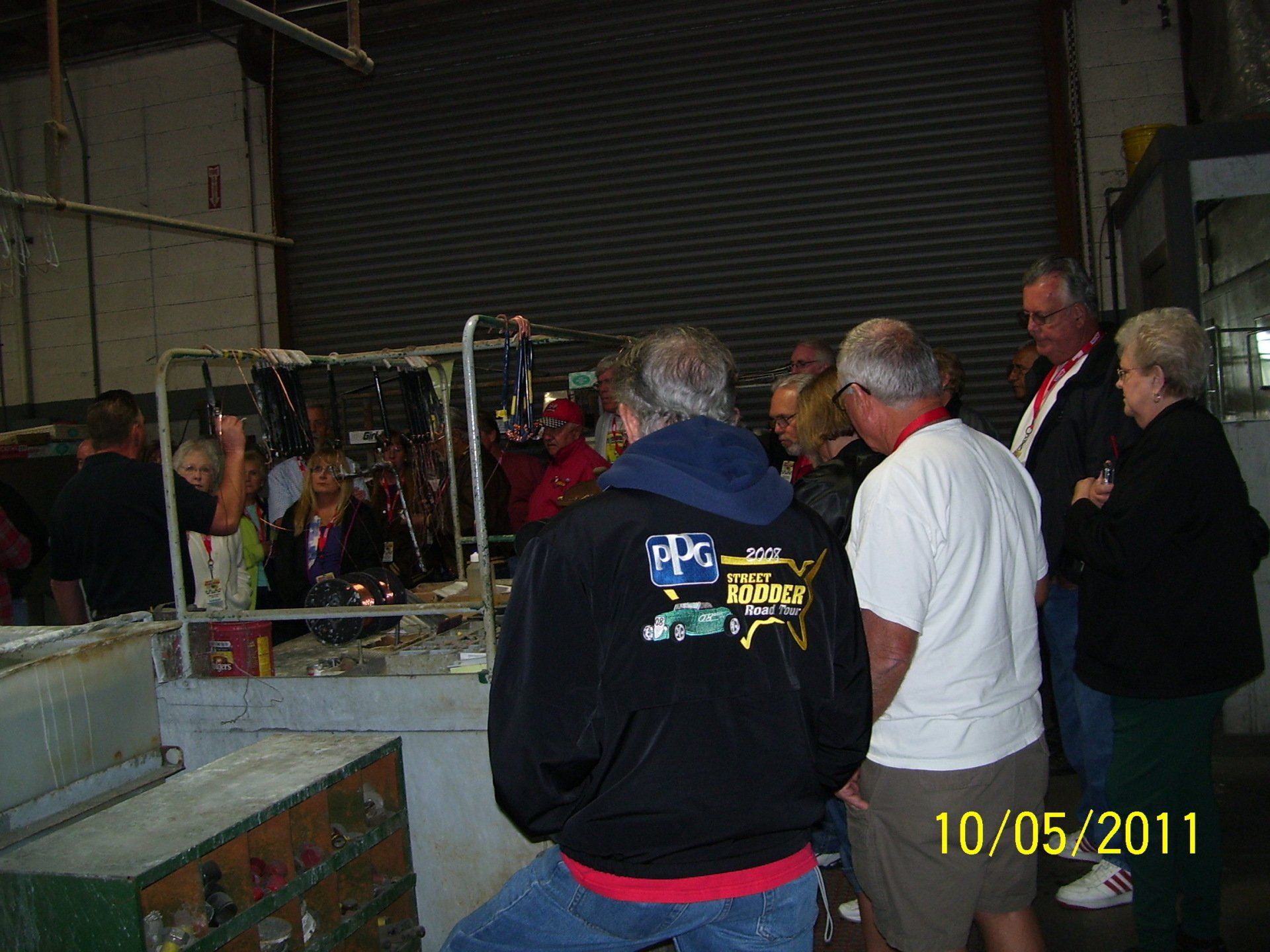 A group of people are gathered in a warehouse on 10/05/11