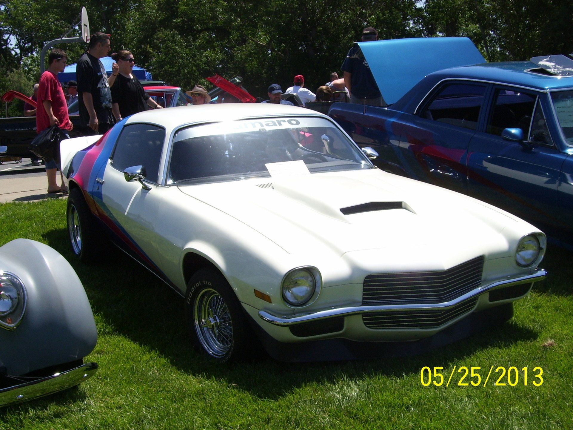 A white car is parked in the grass on 05/25/2013