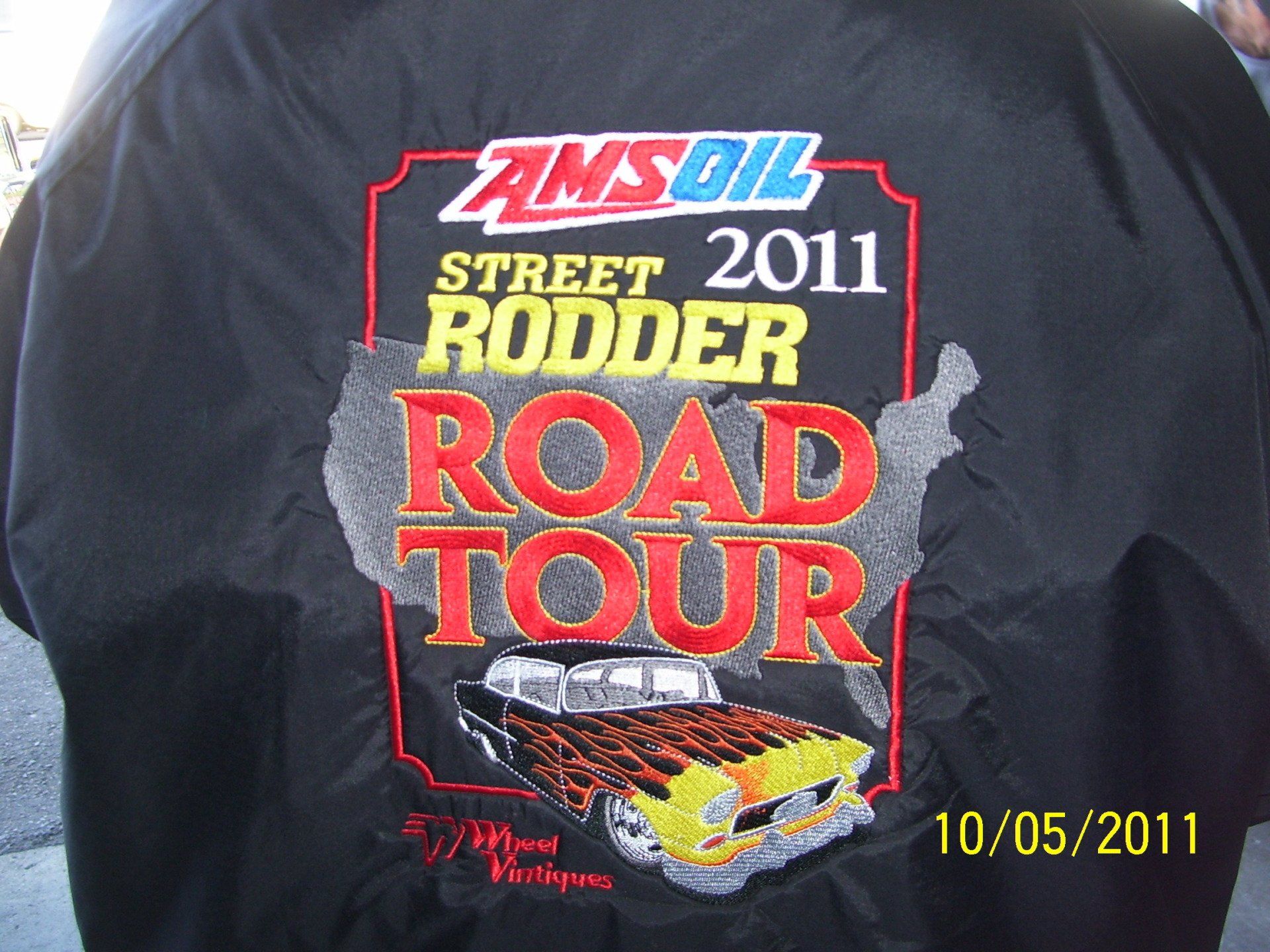 The back of a jacket that says amsoil street rodder road tour