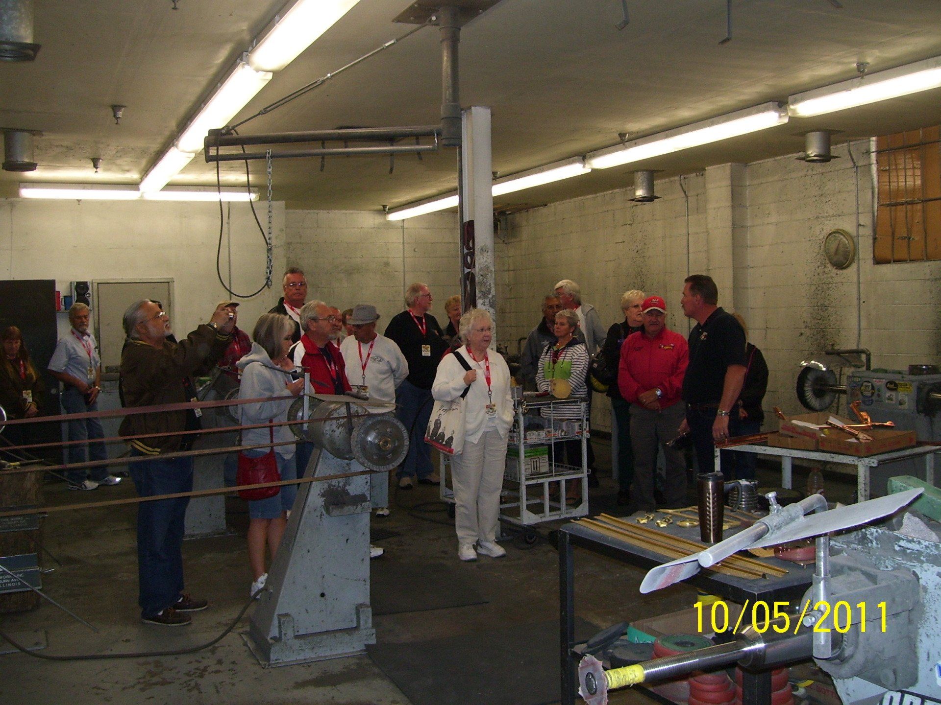 A group of people standing in a room with the date 10/05/11