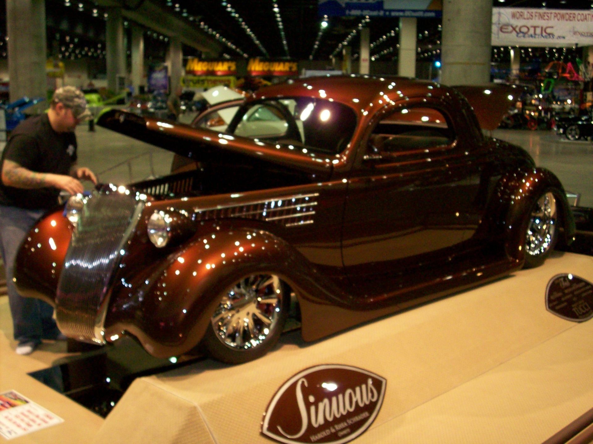 A man standing next to a sinious car