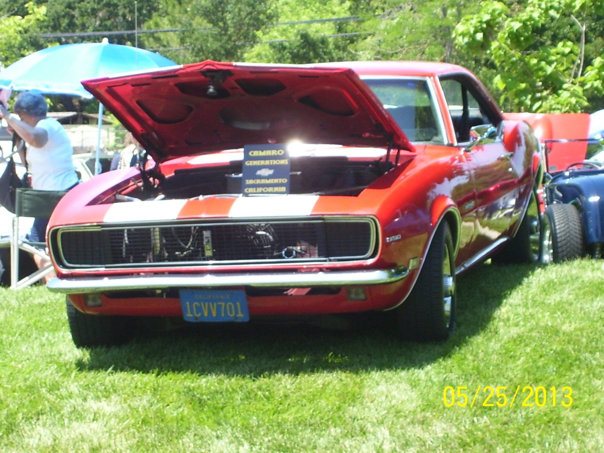 A red car with a license plate that says lc4v101