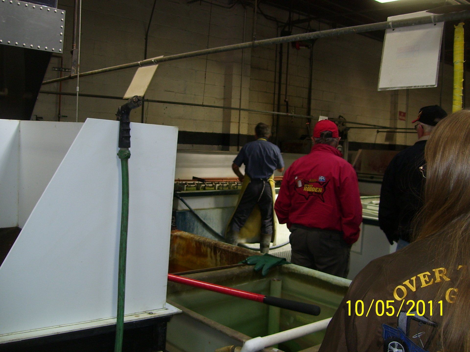 A man in a red jacket has the word over on his back