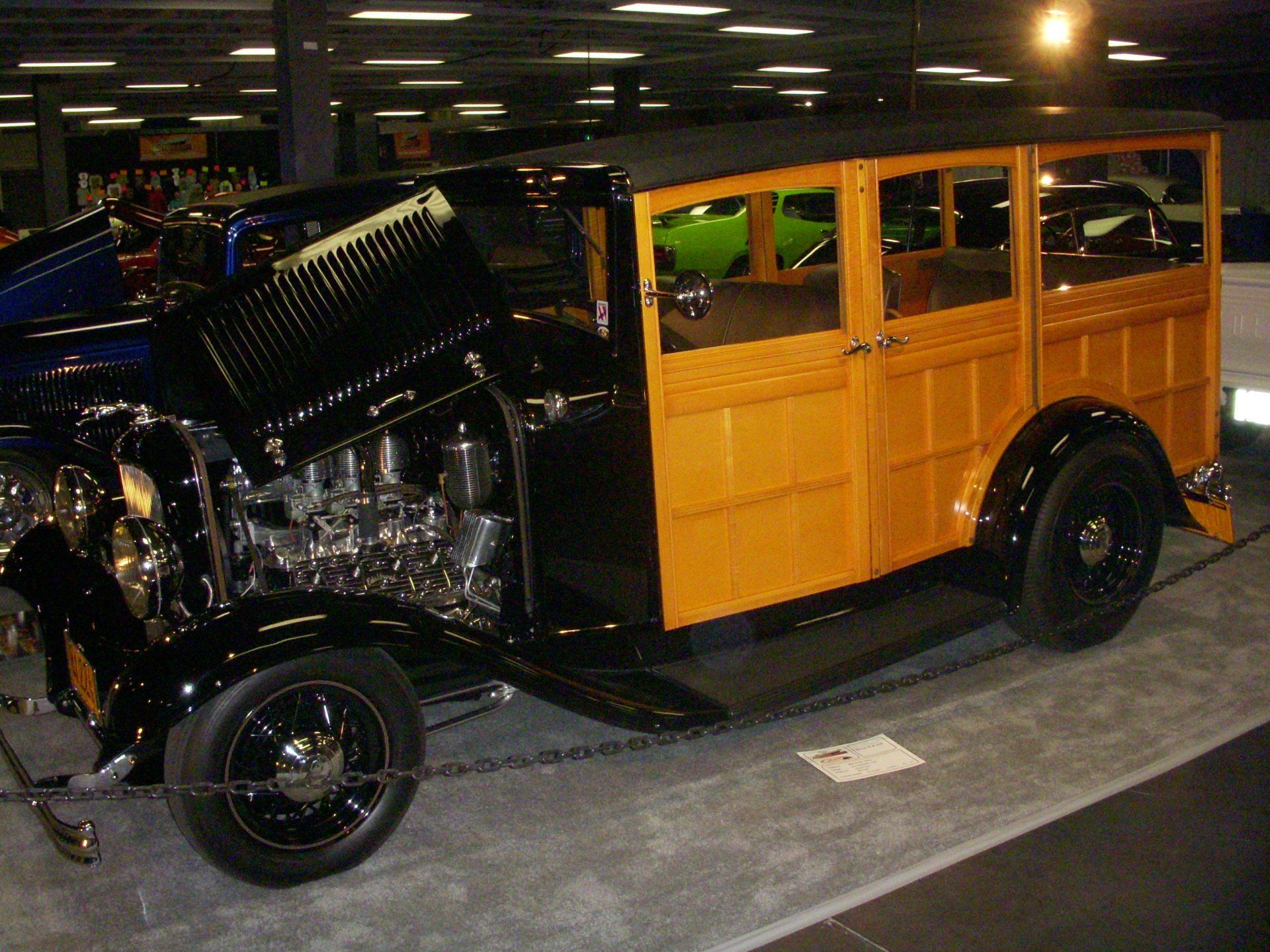 A yellow and black car with the hood open