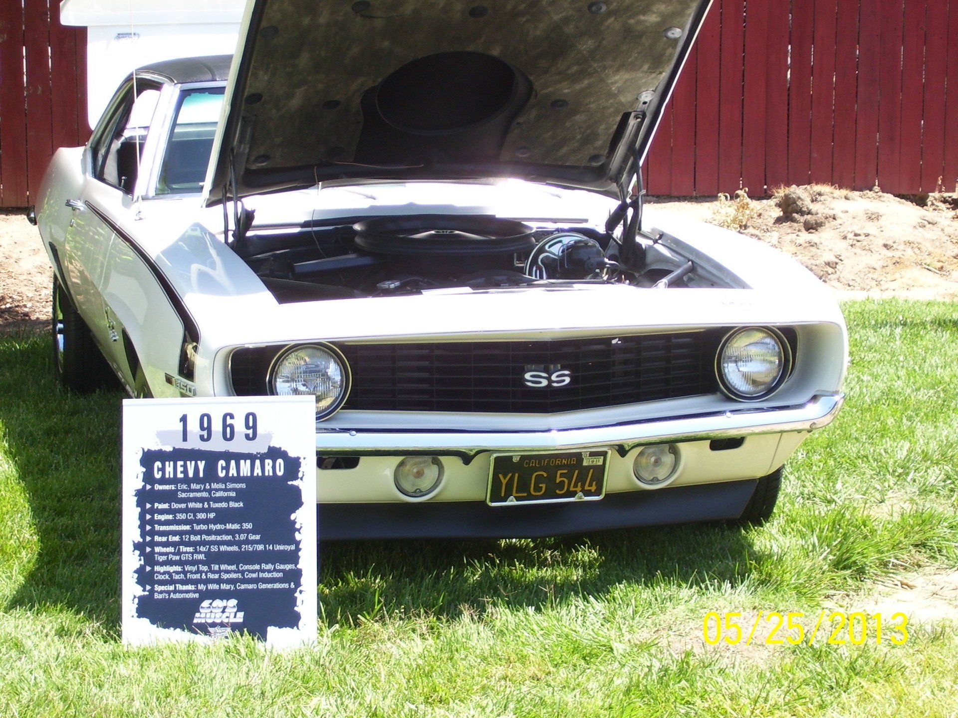 A 1969 chevy camaro is parked in the grass