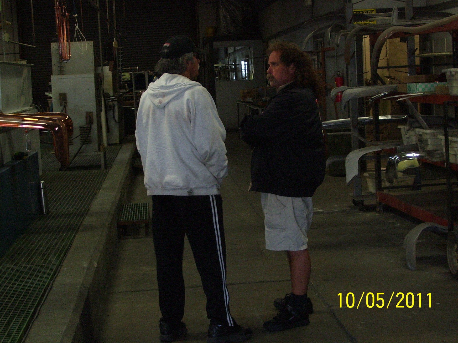 A photo of two men in a factory was taken on 10/05/11