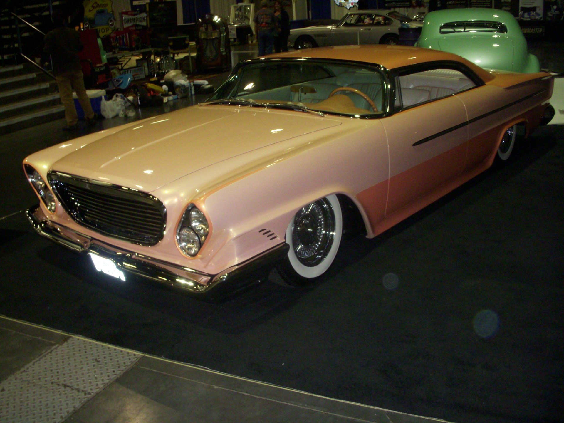 A pink and orange car with white tires