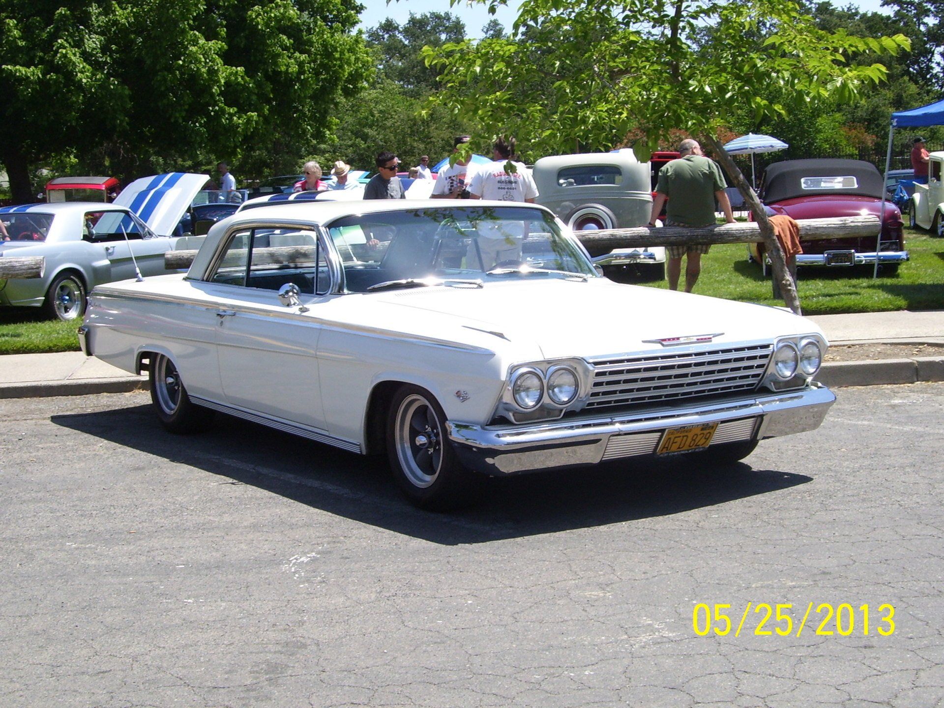 A white chevrolet impala is parked on the side of the road