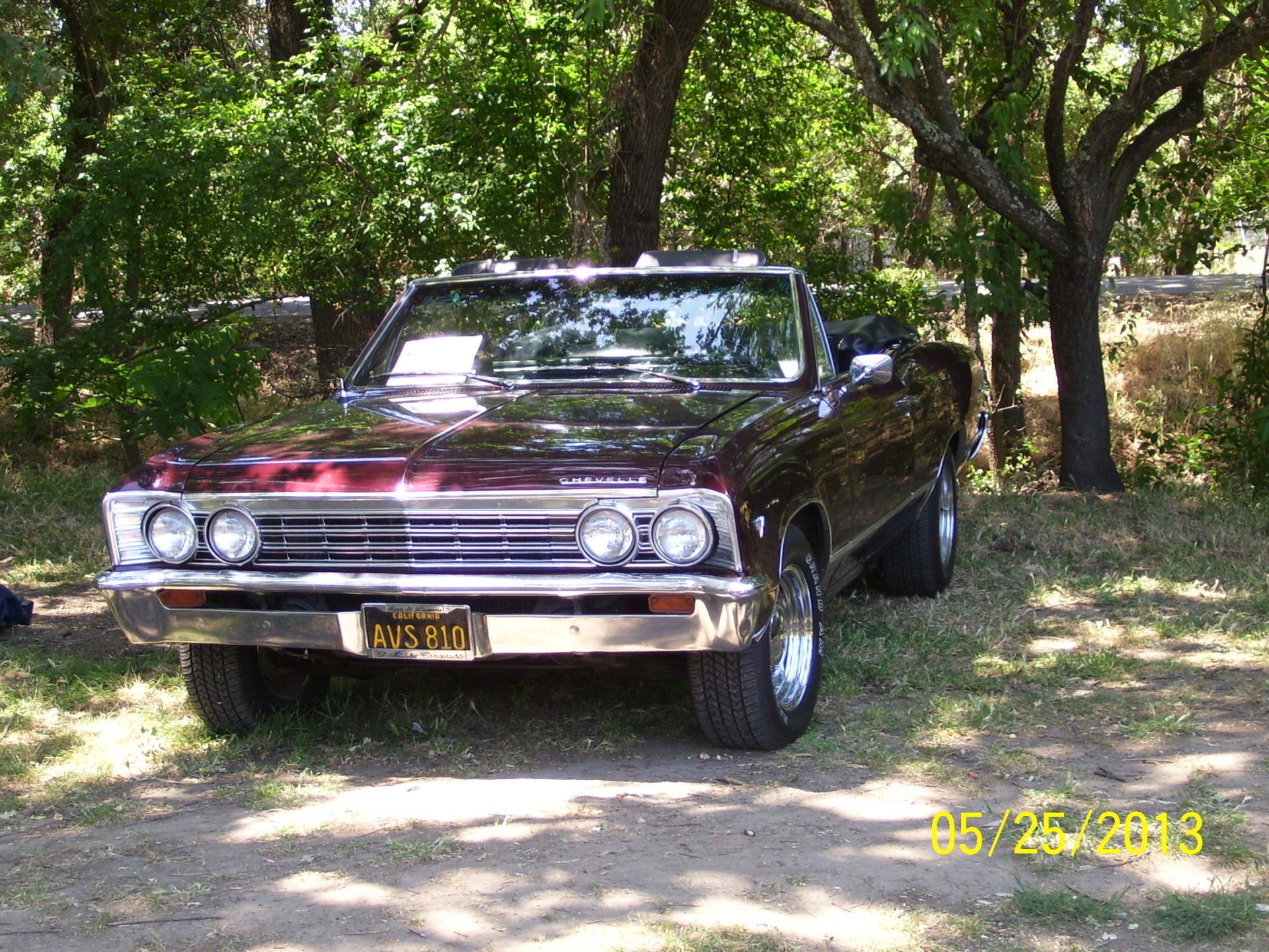 A burgundy car with a license plate that says rvs 10