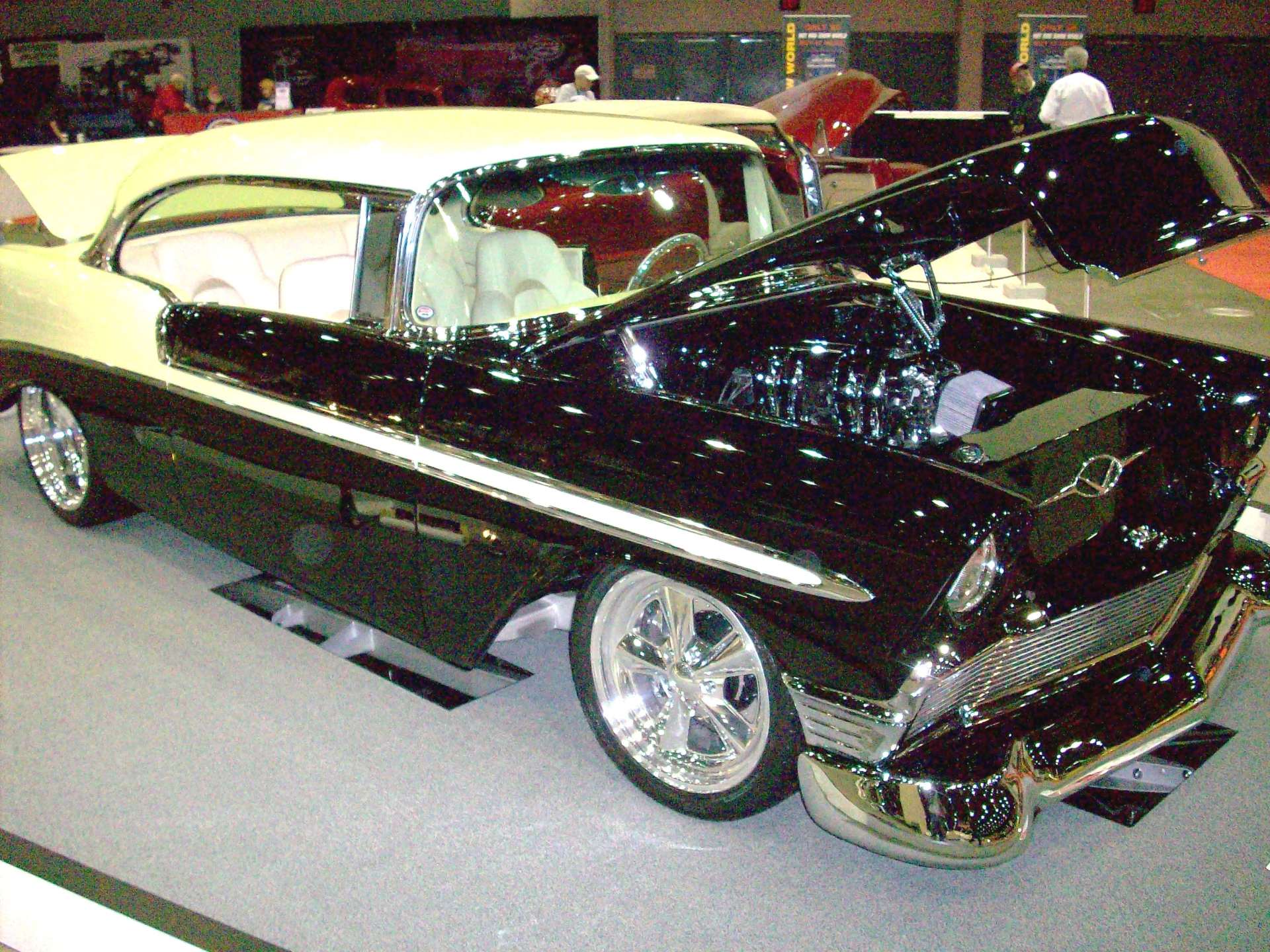 A black and white car with the hood open