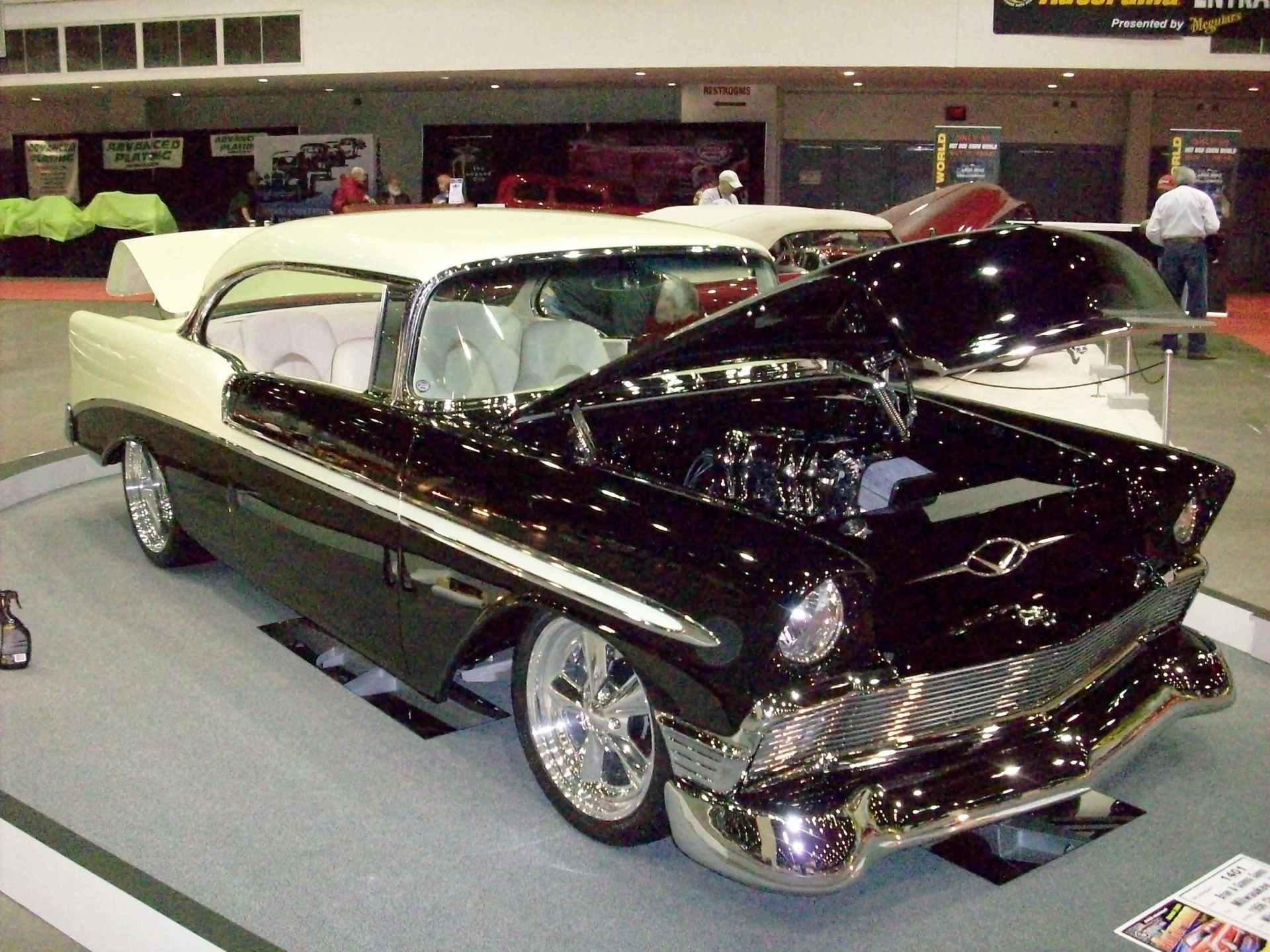 A black and white car with the hood open