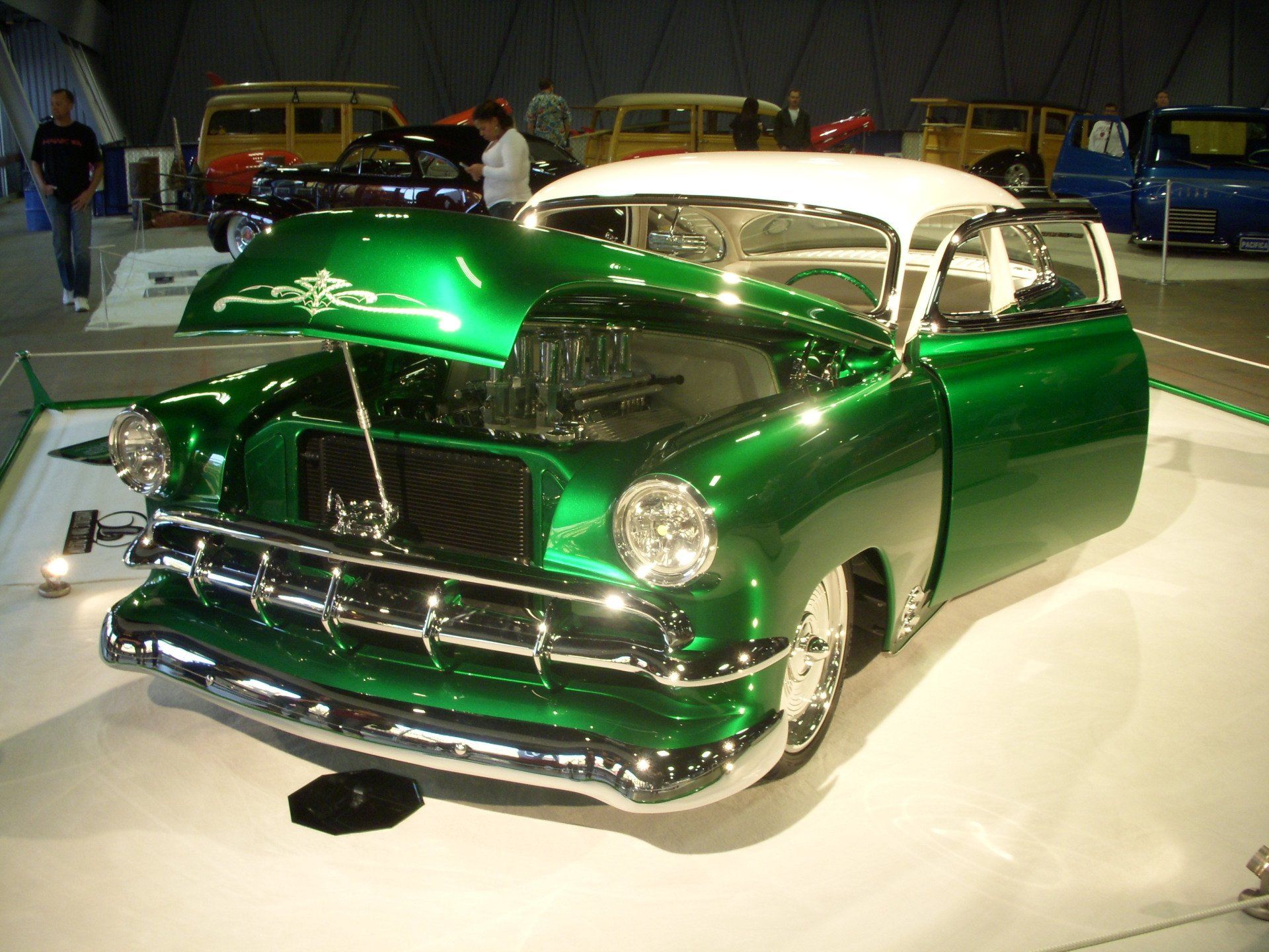 A green and white car with the hood open