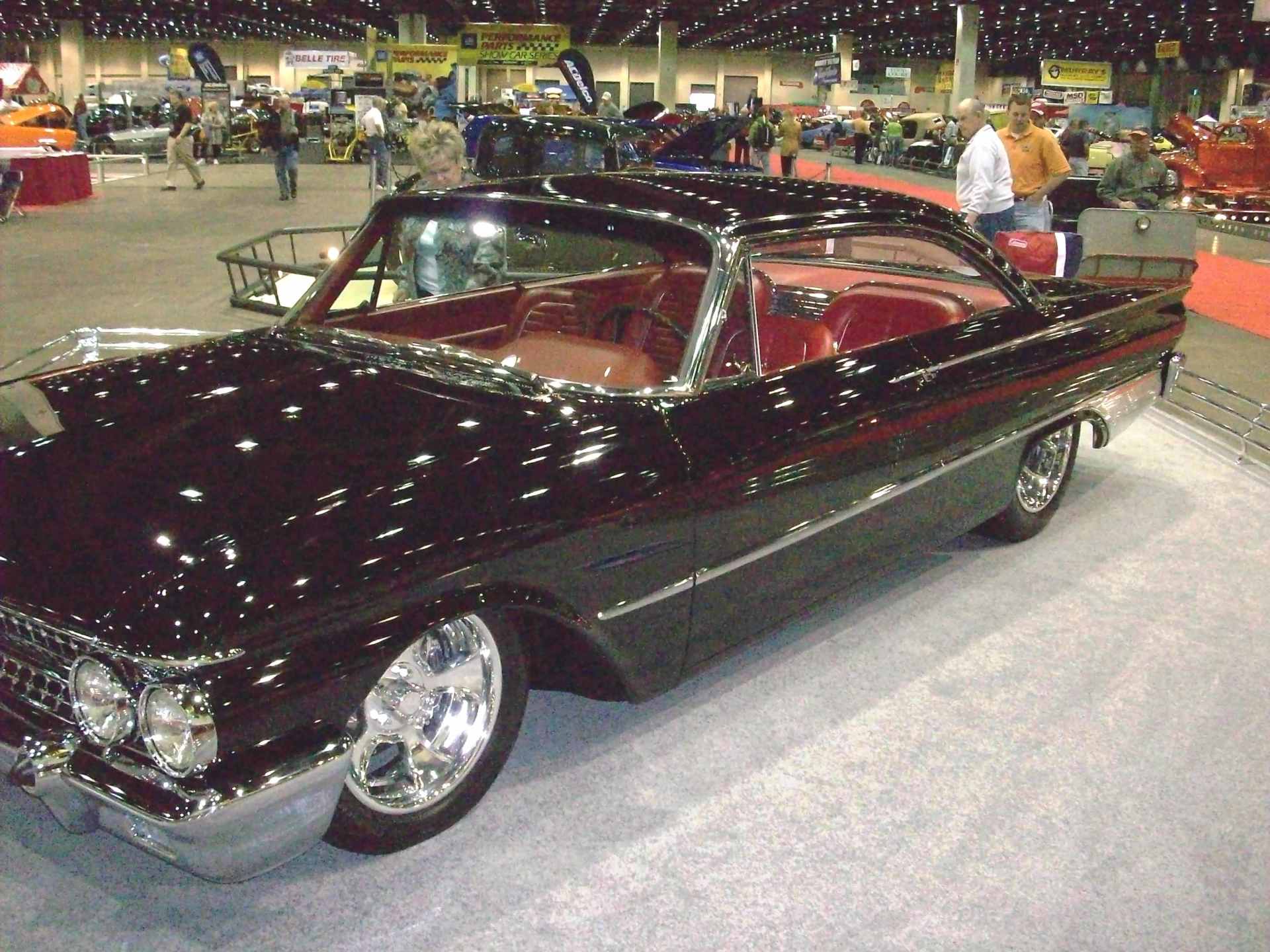 A black car is on display at a car show