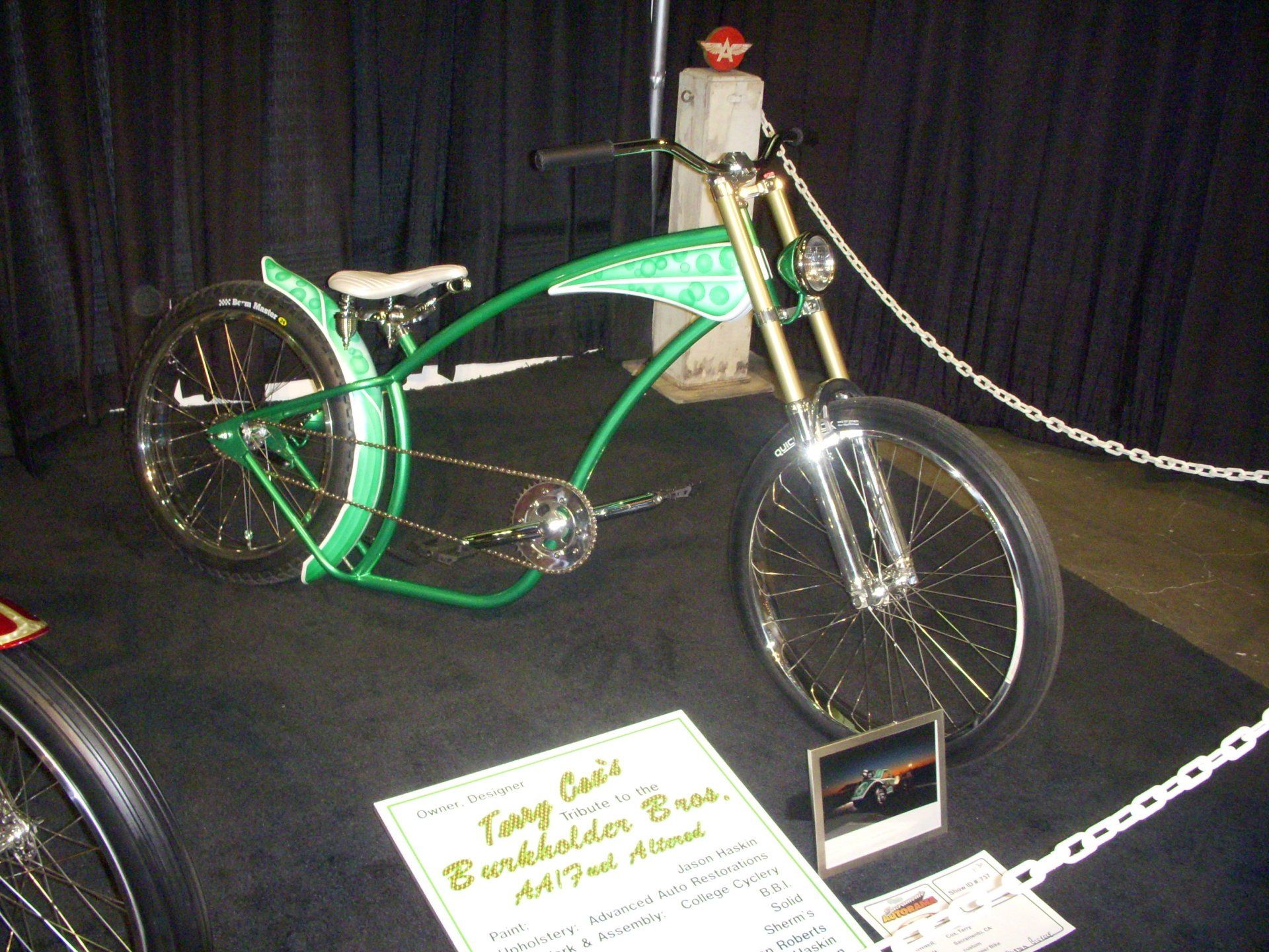 A green bicycle with a sign that says tony cole