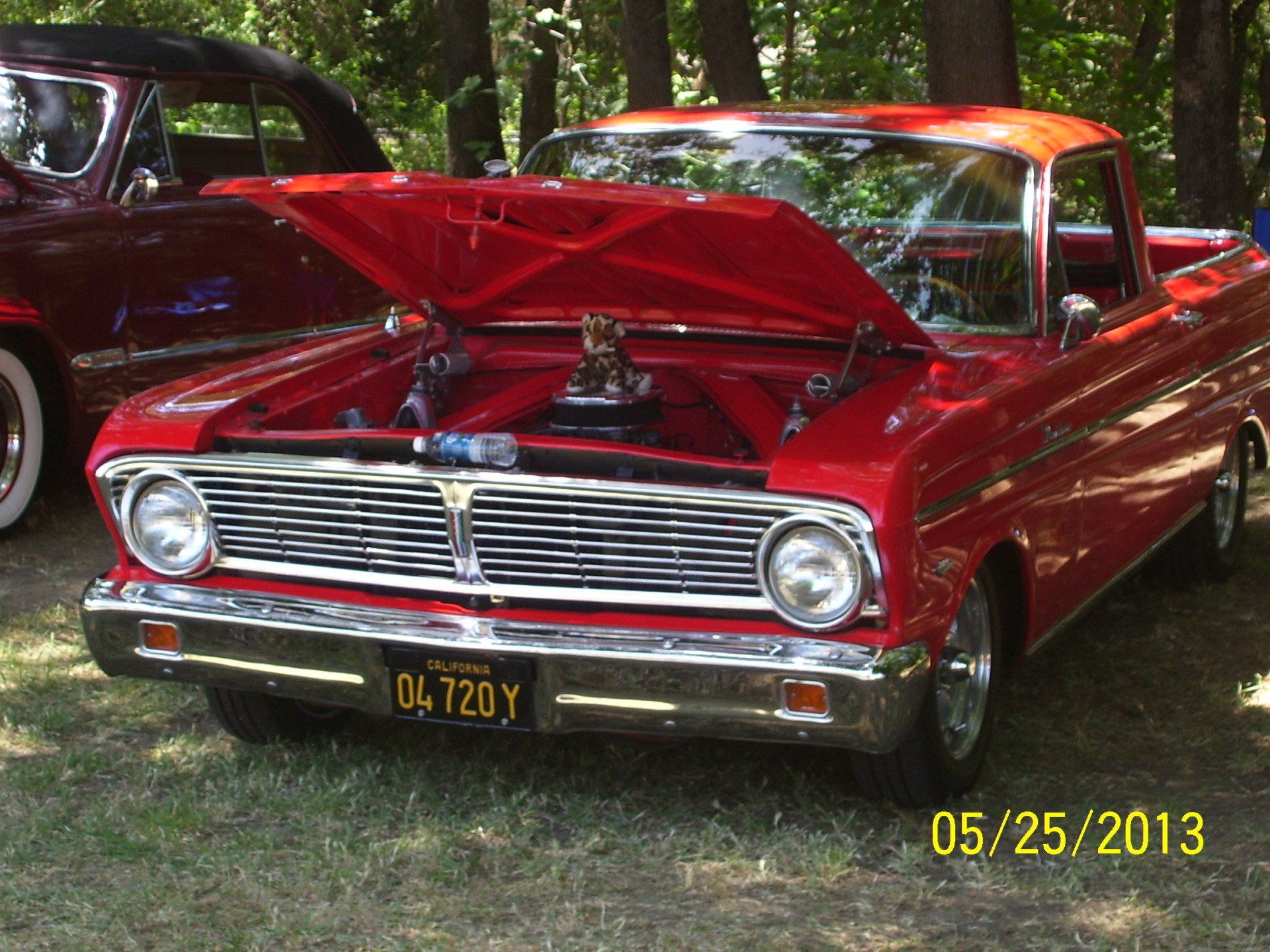 A red pickup truck with a license plate that says 04720y