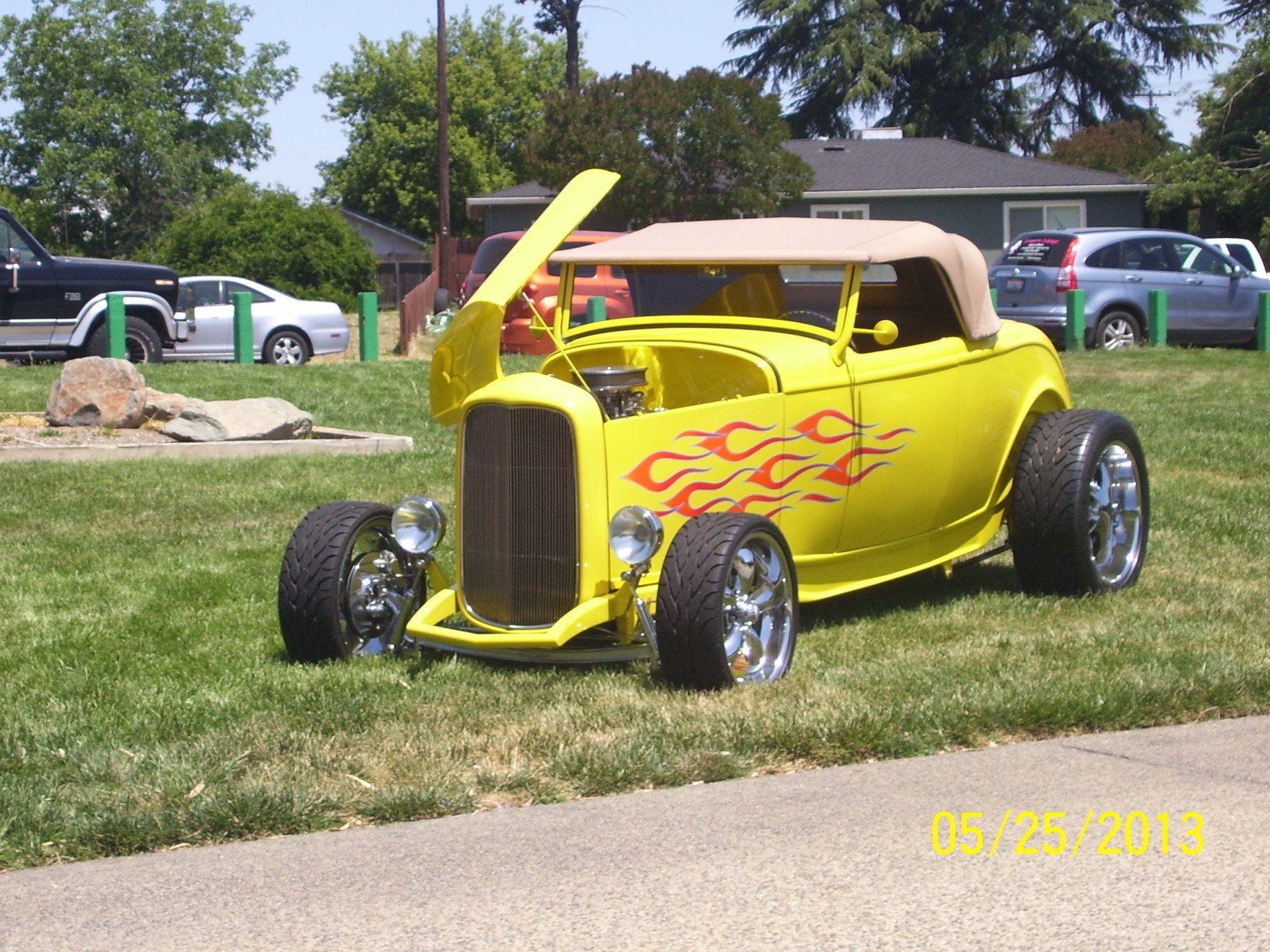 A yellow car with flames painted on it