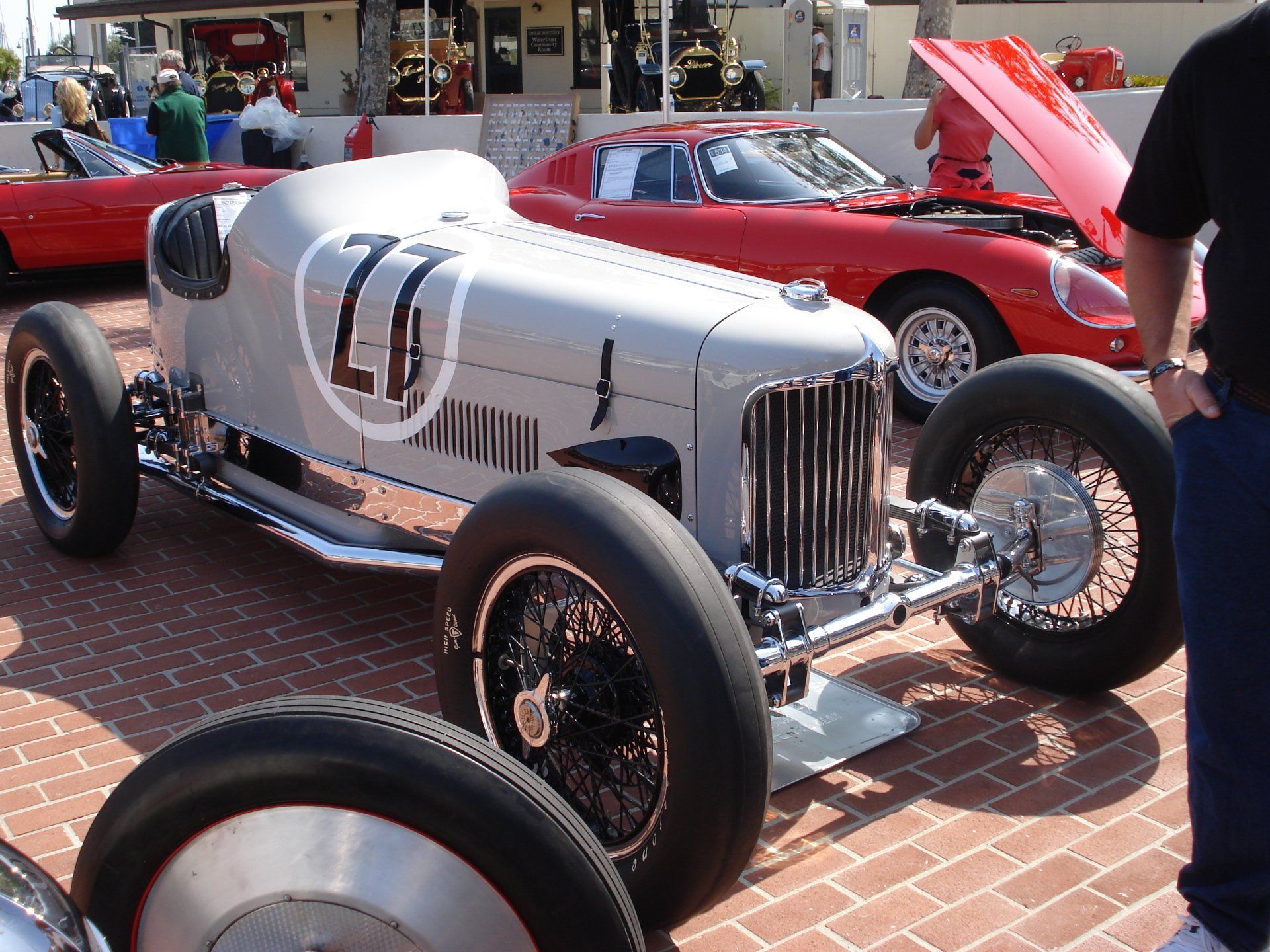 A silver race car with the number 77 on the side