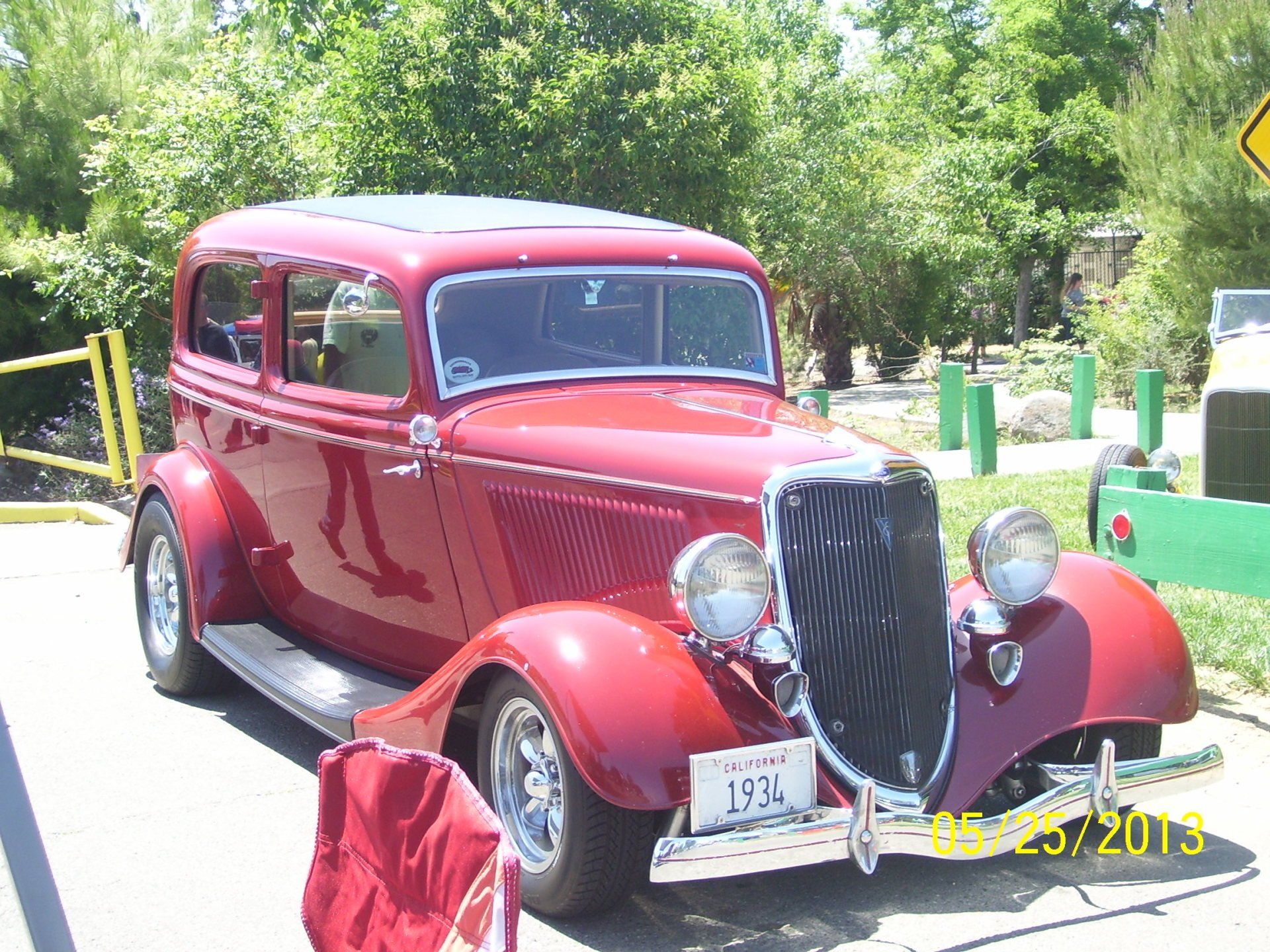 A red vintage car with a license plate that says ln33