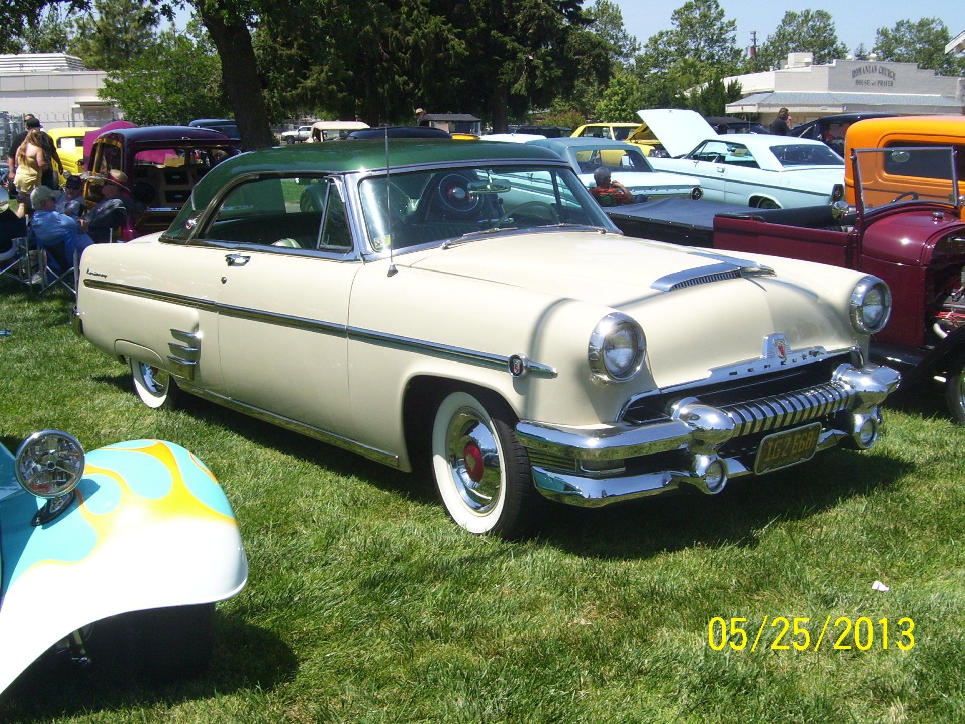An old car is parked in a grassy field on 05/25/2013